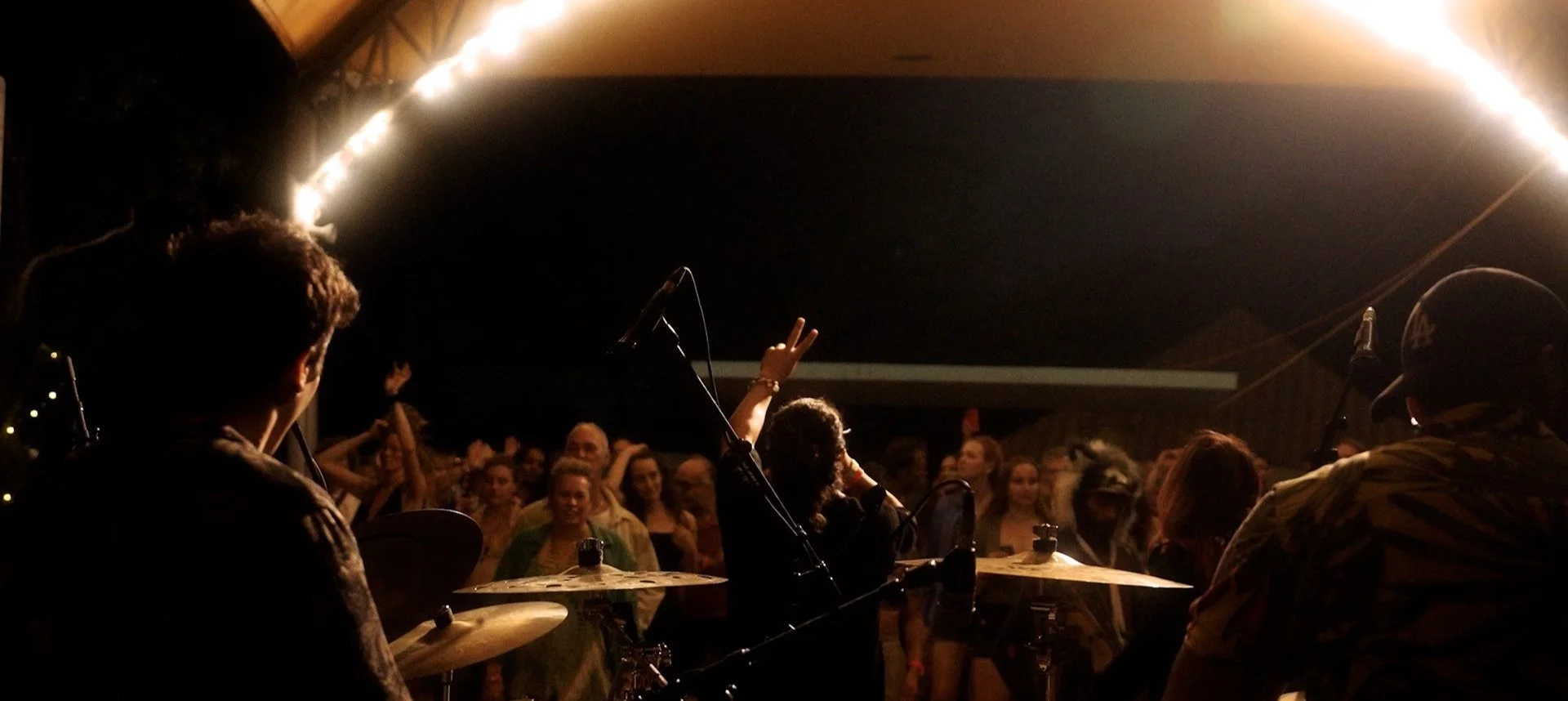 Live music performance in a dark indoor venue with a band playing for an attentive audience.