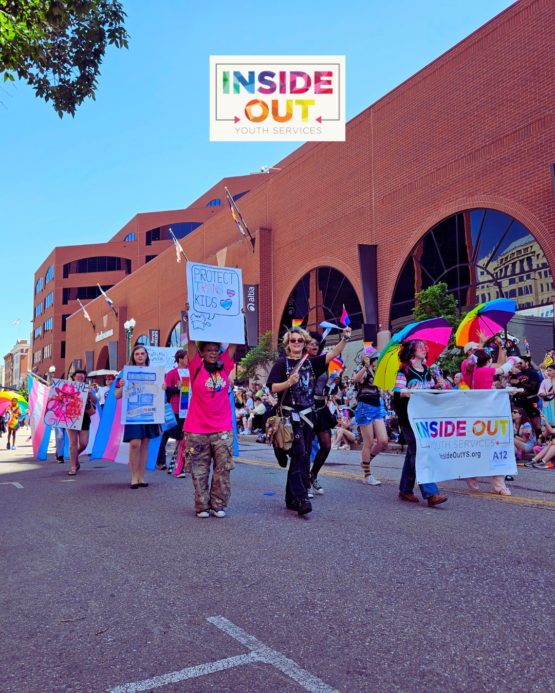  Young people in colorful clothes march in the Pikes Peak Pride parade 