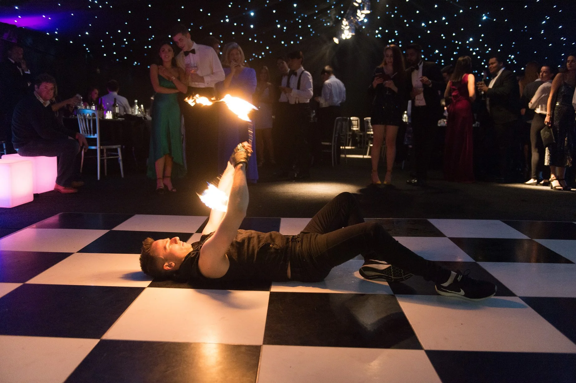 Fire poi performer delivering a captivating flame performance at a wedding, festival or corporate event