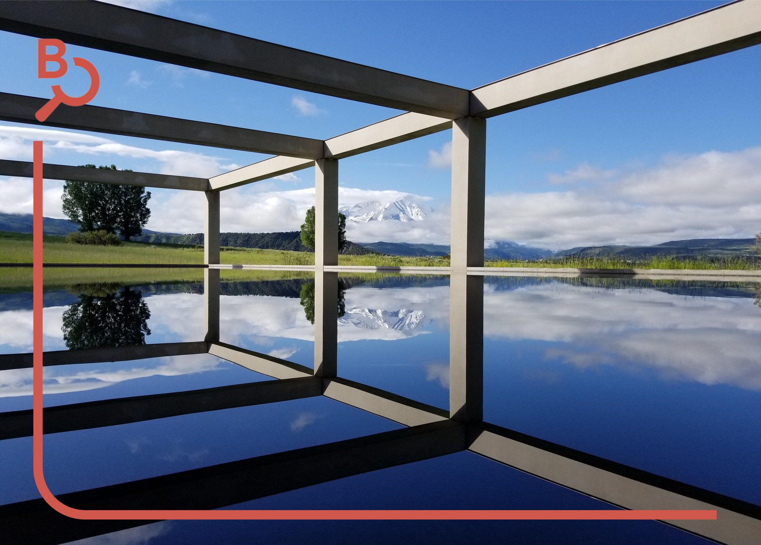 Landscape with trees, mountains, and cloudy sky reflected in a mirror-like surface, framed by a geometric structure.
