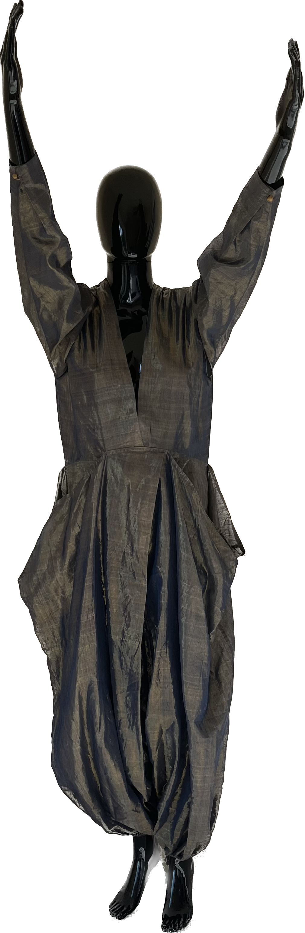 Mannequin wearing a dark, textured, voluminous jumpsuit with wide legs and long sleeves, posed with arms raised.