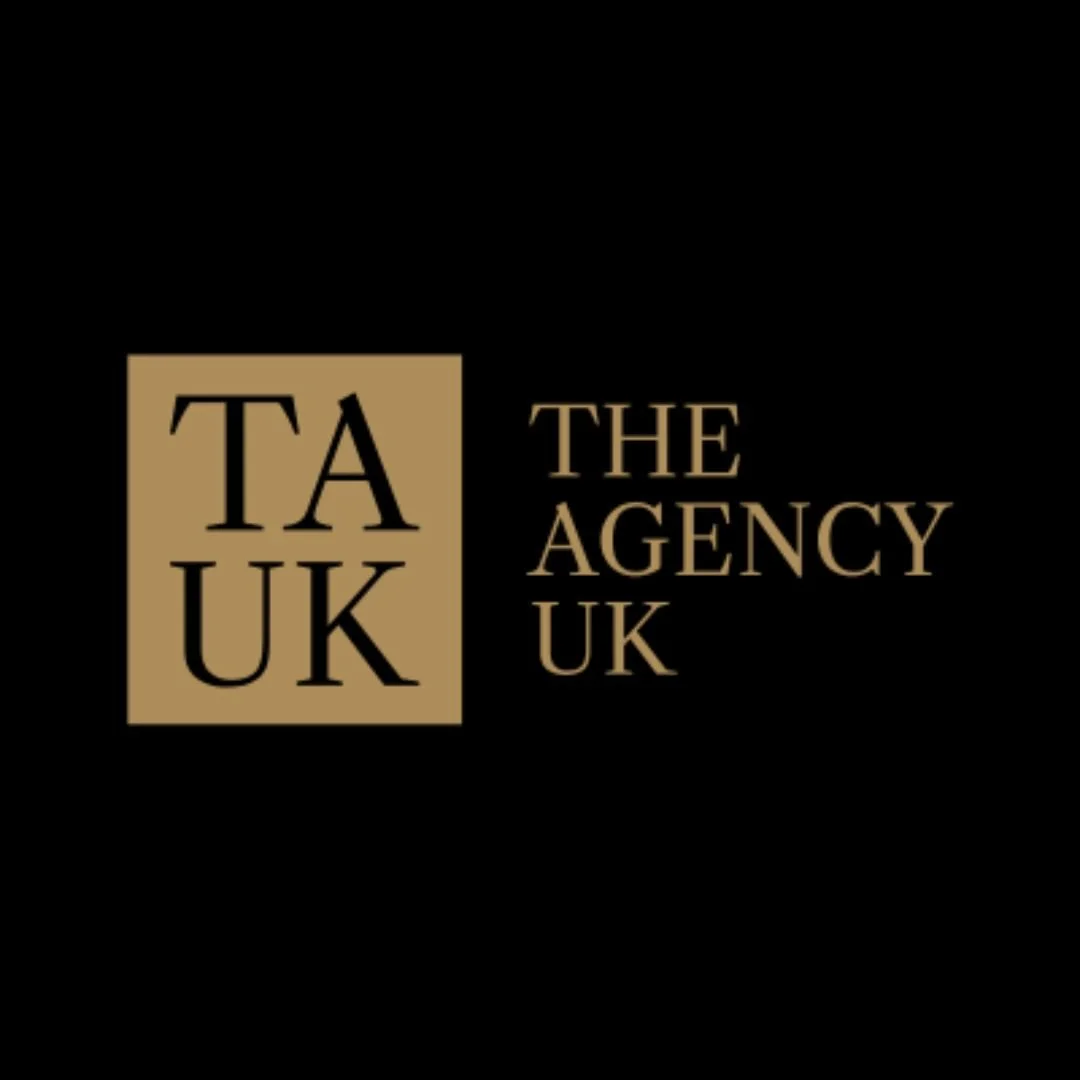 The logo of TA UK, The Agency UK, featuring a black background with a gold square containing the initials 'TA UK' and gold text reading 'The Agency UK' to the right of the square.