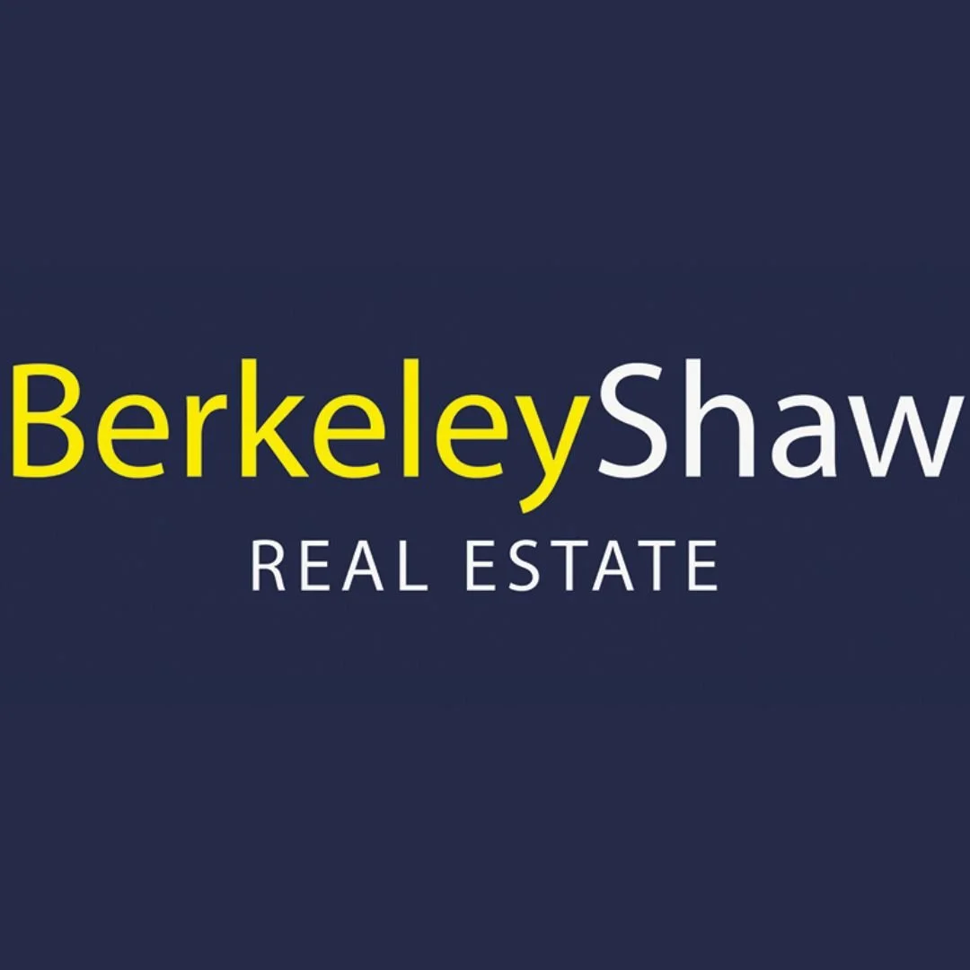 Logo for Berkeley Shaw Real Estate with text in yellow and white on a dark blue background.