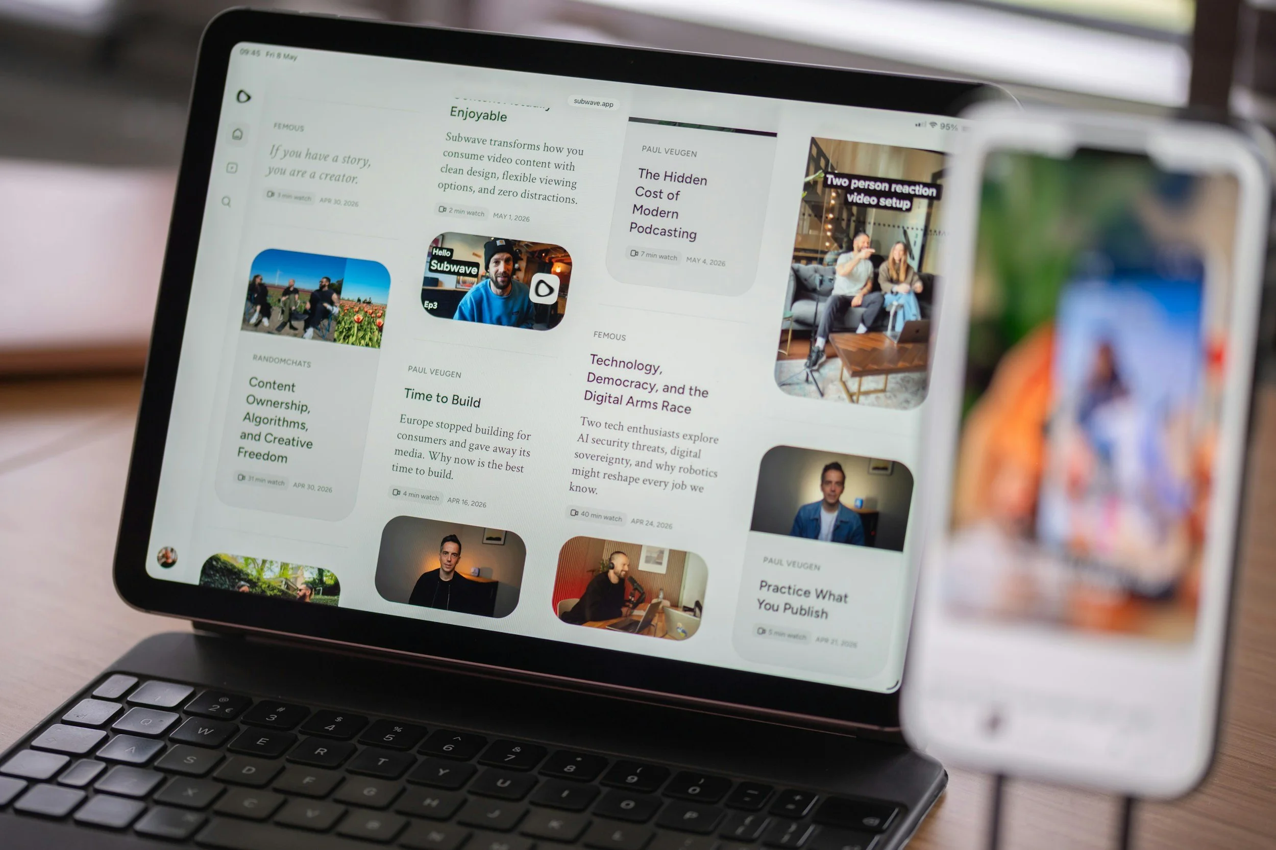 A laptop screen displaying a website with various articles, videos, and thumbnails about digital content, media, and technology topics, with a keyboard visible in the foreground.
