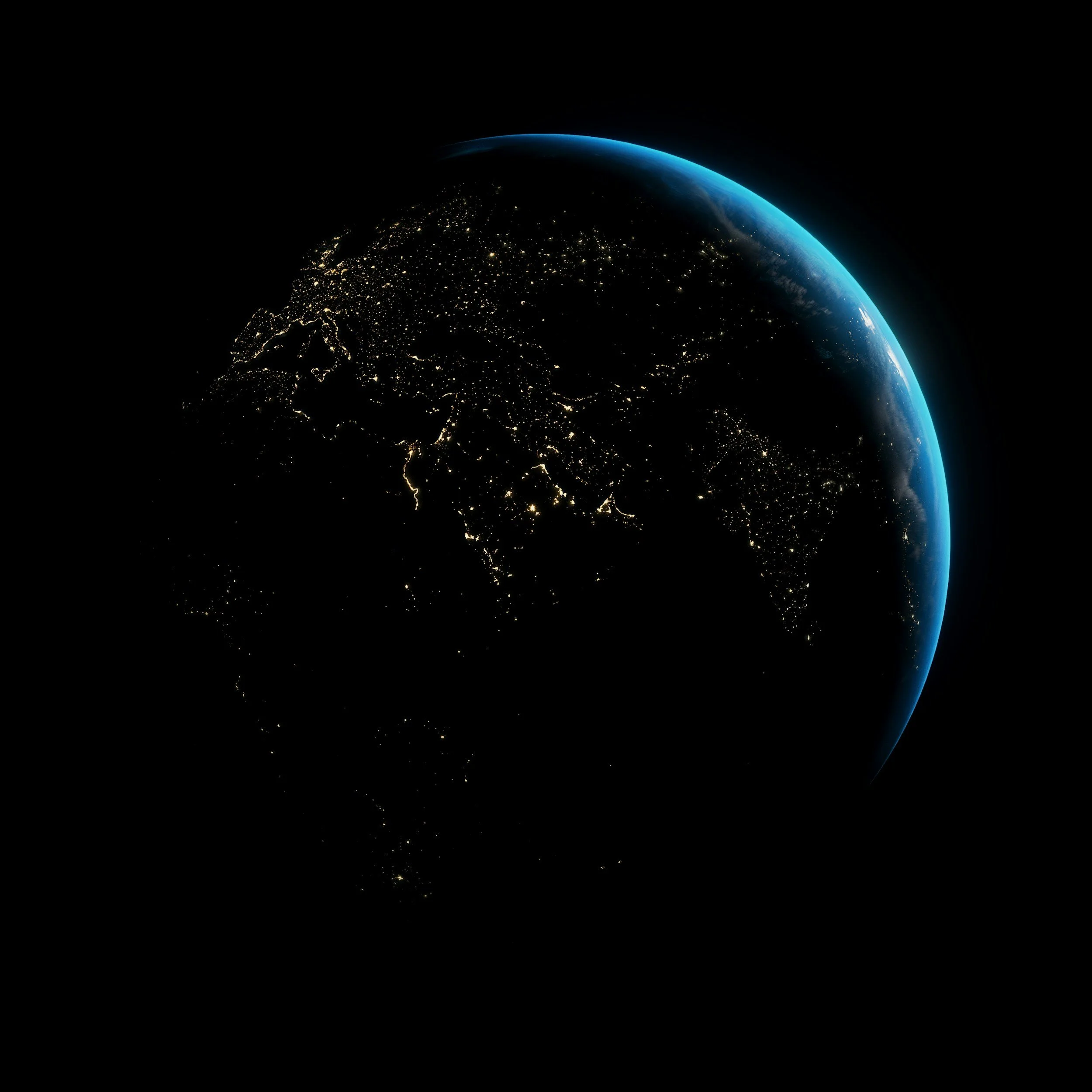 View of Earth from space showing North America at night with illuminated cities and the curved blue atmosphere.