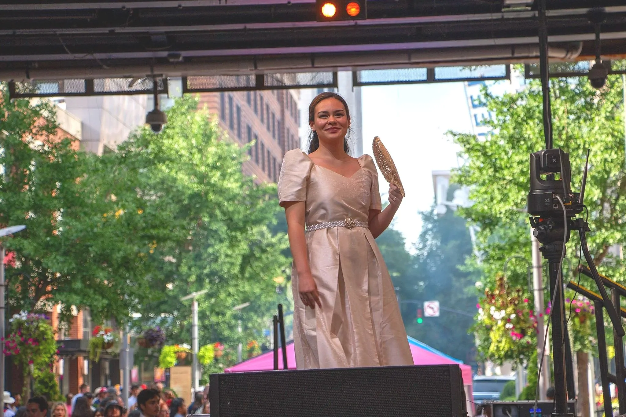 Model Jean Gray wears holds a traditional Filipino fan and wears a modern Filipiniana dress custom made from the Philippines. (Photo by McKenzie Gary, 2026.)