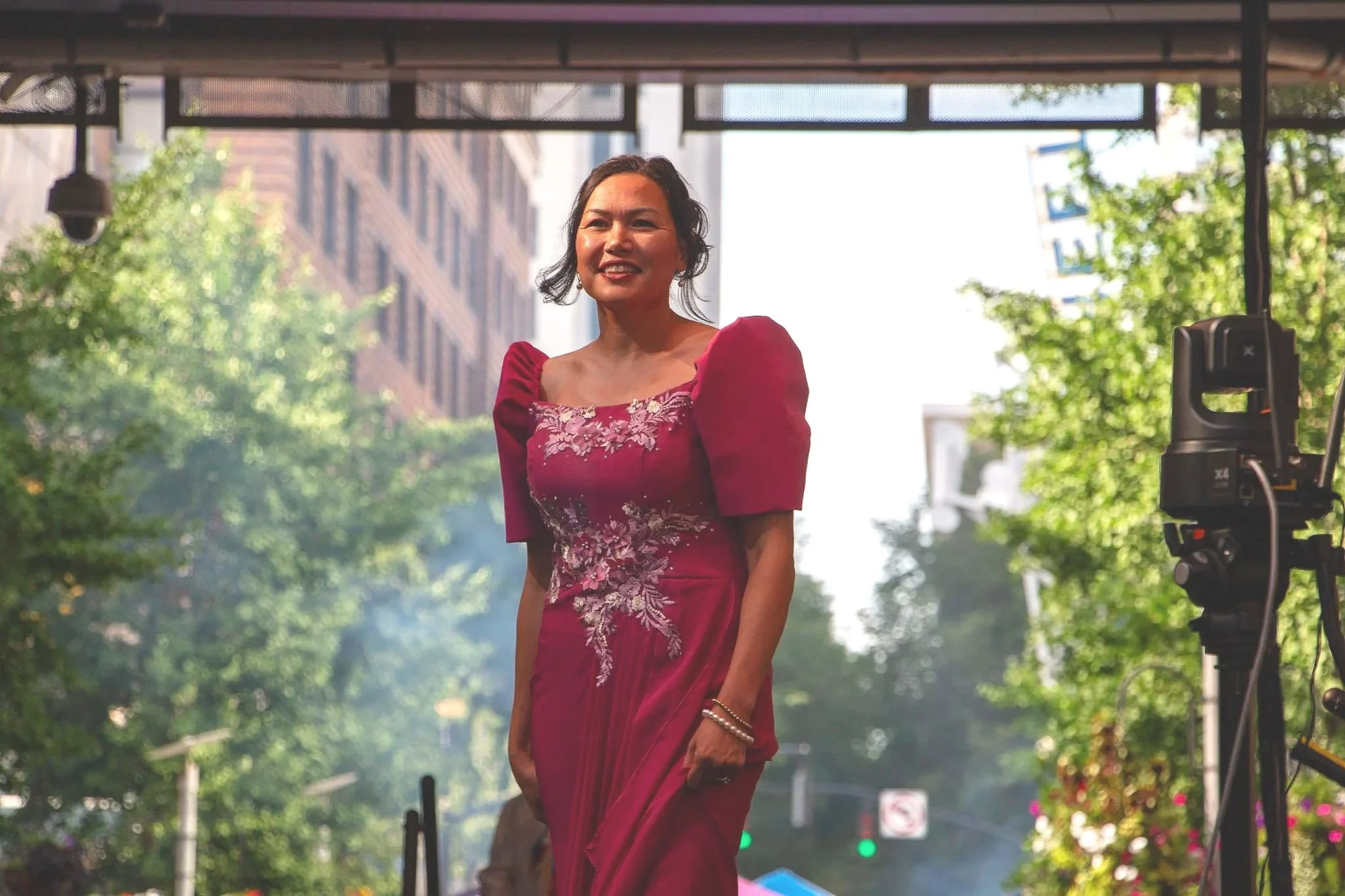 Doris Sims wears a bold fuschia Filipiniana dress with beaded embroidery. (Photo by McKenzie Gary, 2026.)