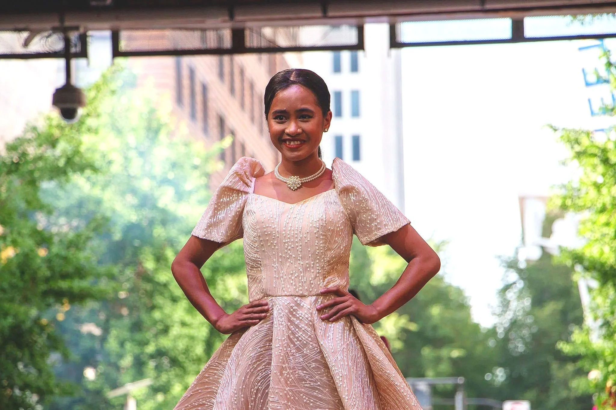 Creme Stewart model displays her champagne colored Filipiniana. (Photo by McKenzie Gary, 2026.)