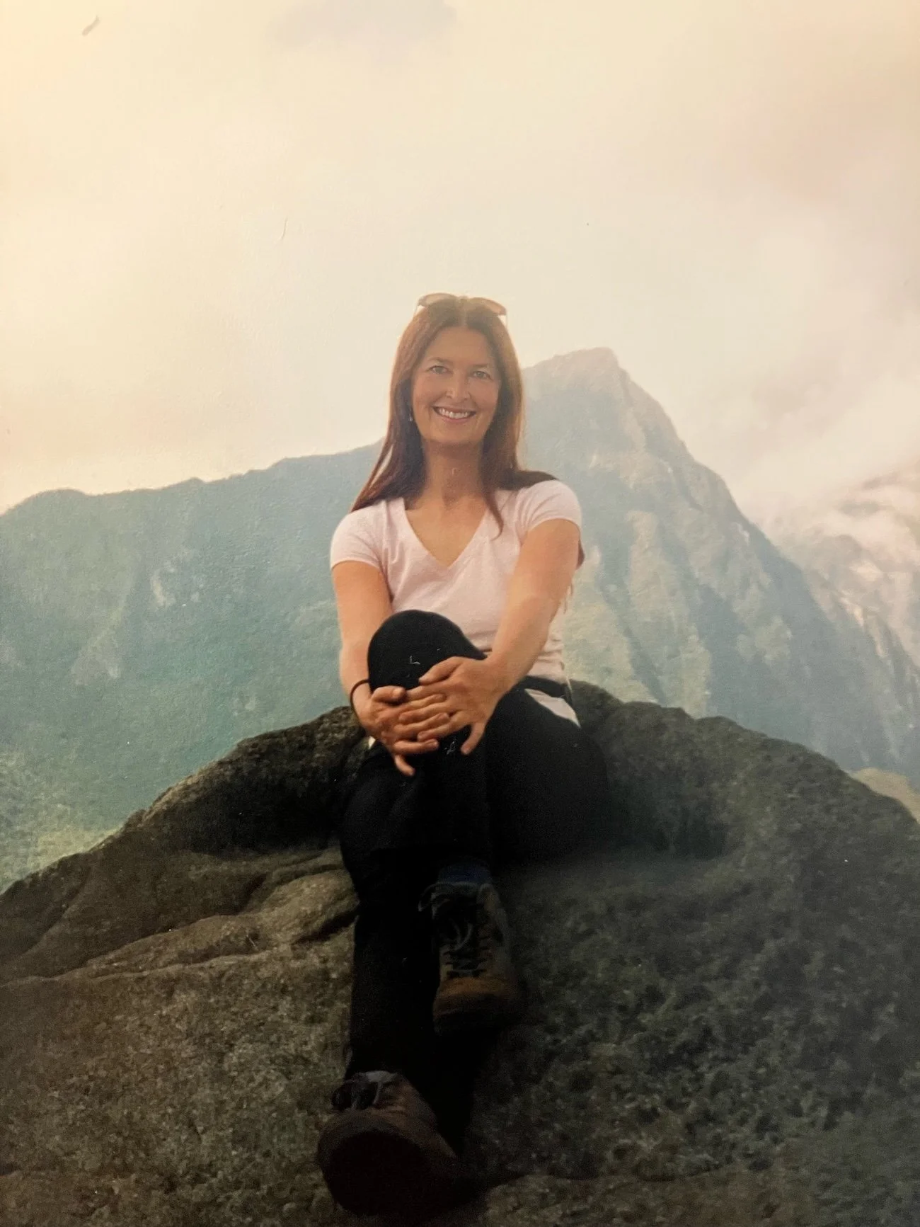Astrologer Kylie Frank sitting high on the Machu Piccu sacred mountain.