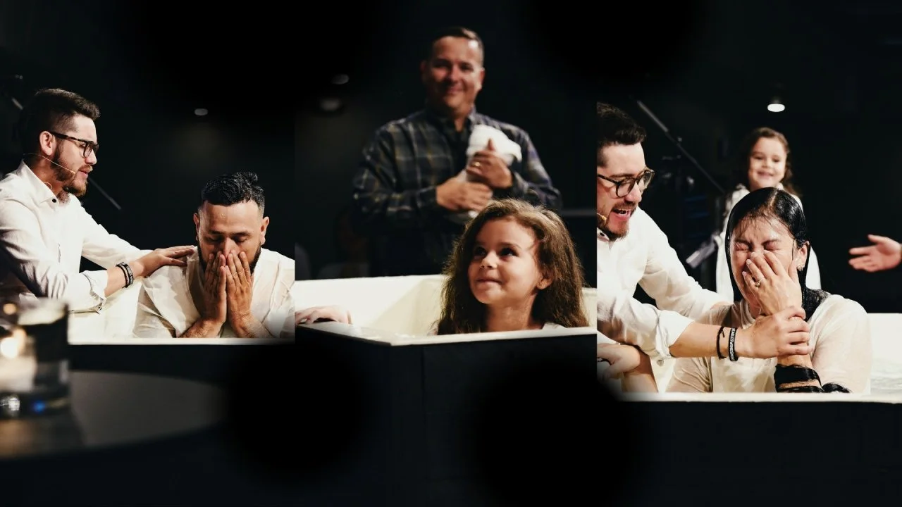 People at a baptism ceremony, with a woman crying tears of happiness while a man shows support, and a girl looks on with curiosity.
