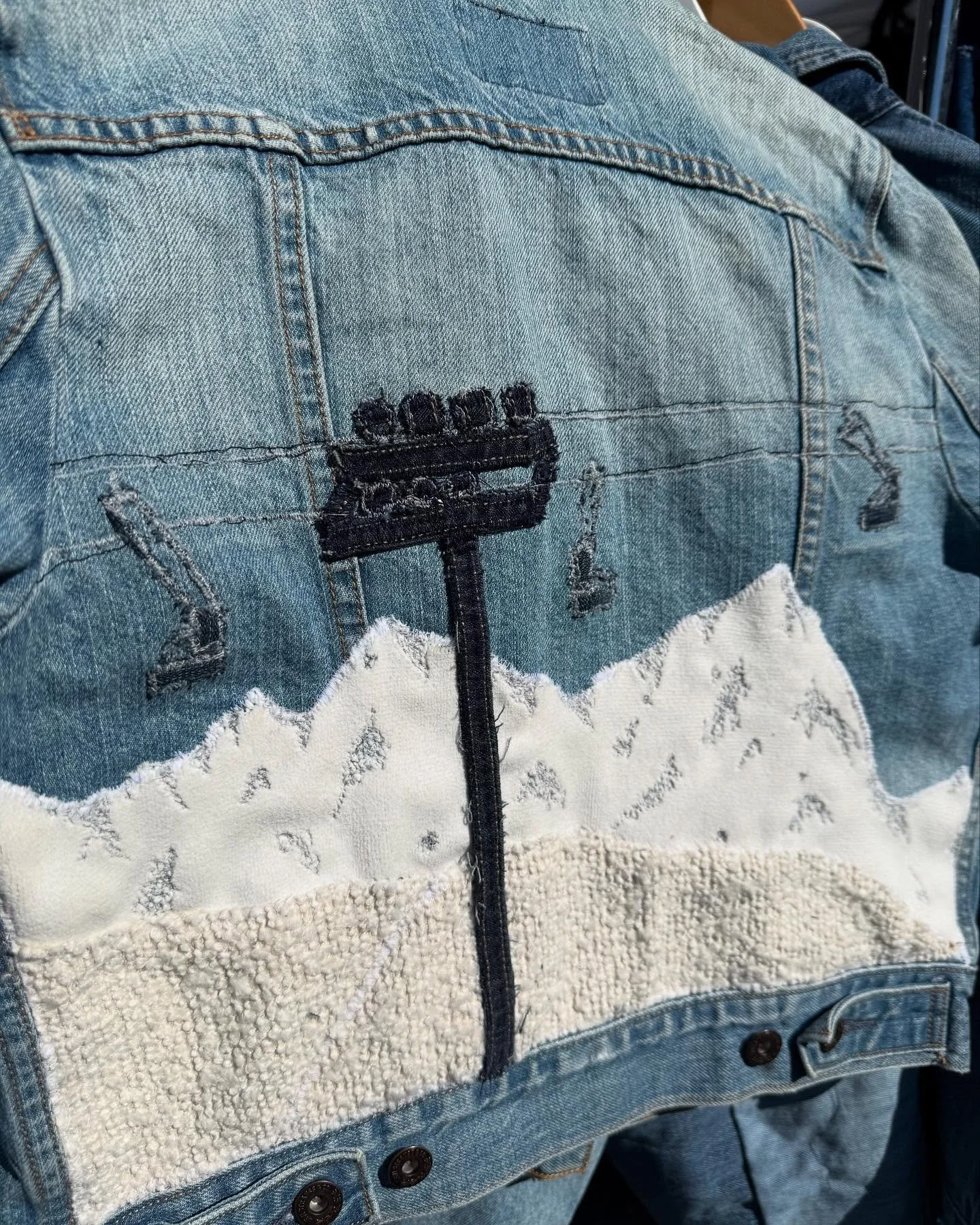 Ski Lift Jacket came and went! Mountains made from a waterproof fabric, snow base made from scrapped upholstery, and the lift from denim seams!