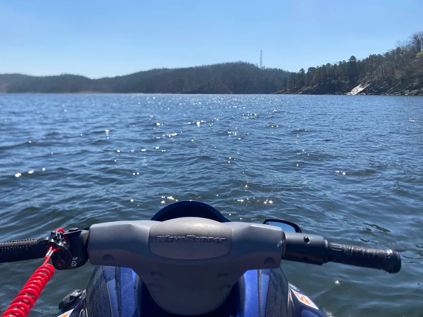 A happy Hills and Thrills customer enjoying the beautiful views of Broken Bow Lake from a rented jet ski!