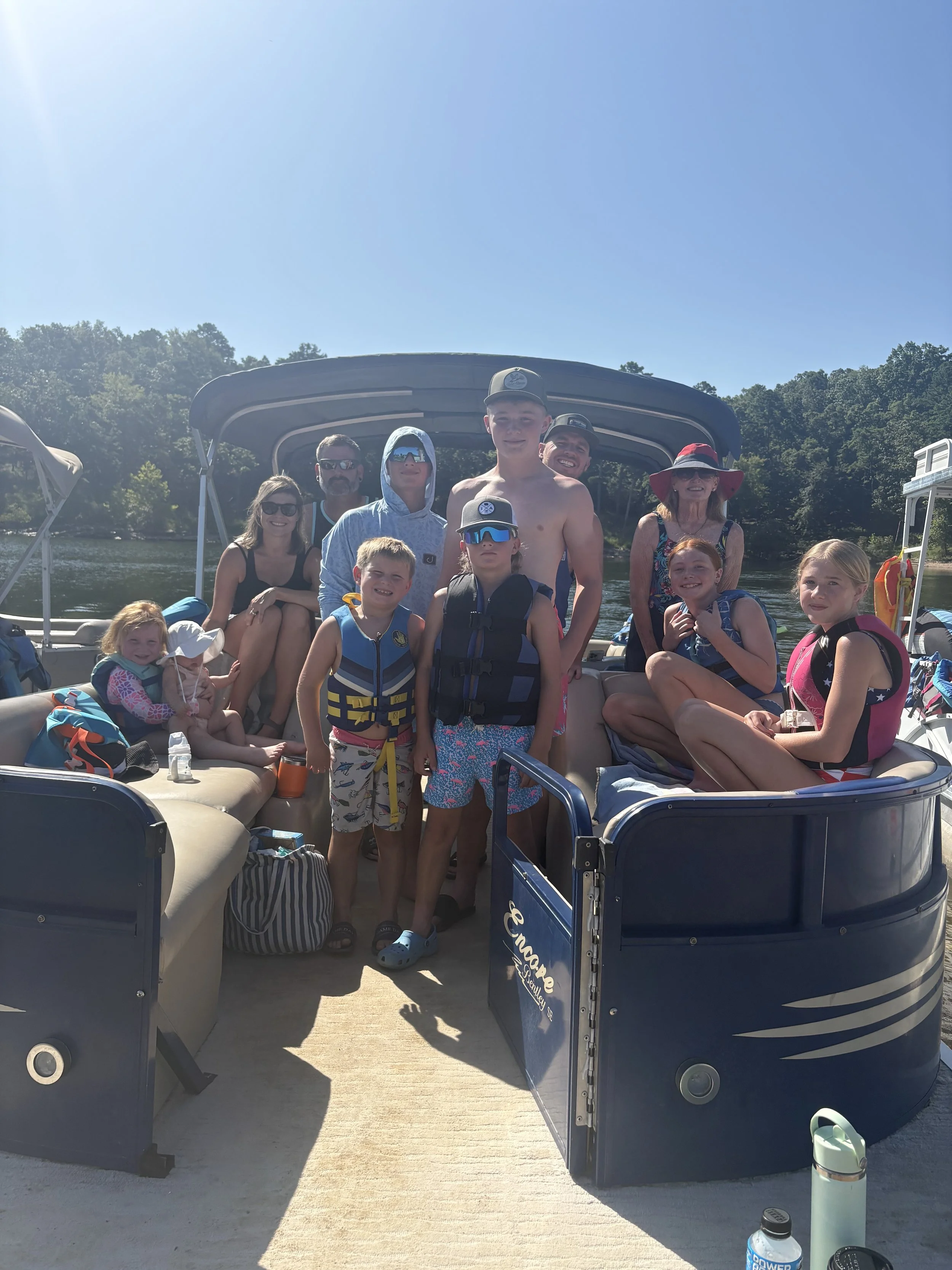 Large family with kids enjoying Broken Bow Lake and Hochatown with a pontoon boat rental from Hills and Thrills Boat Rental.