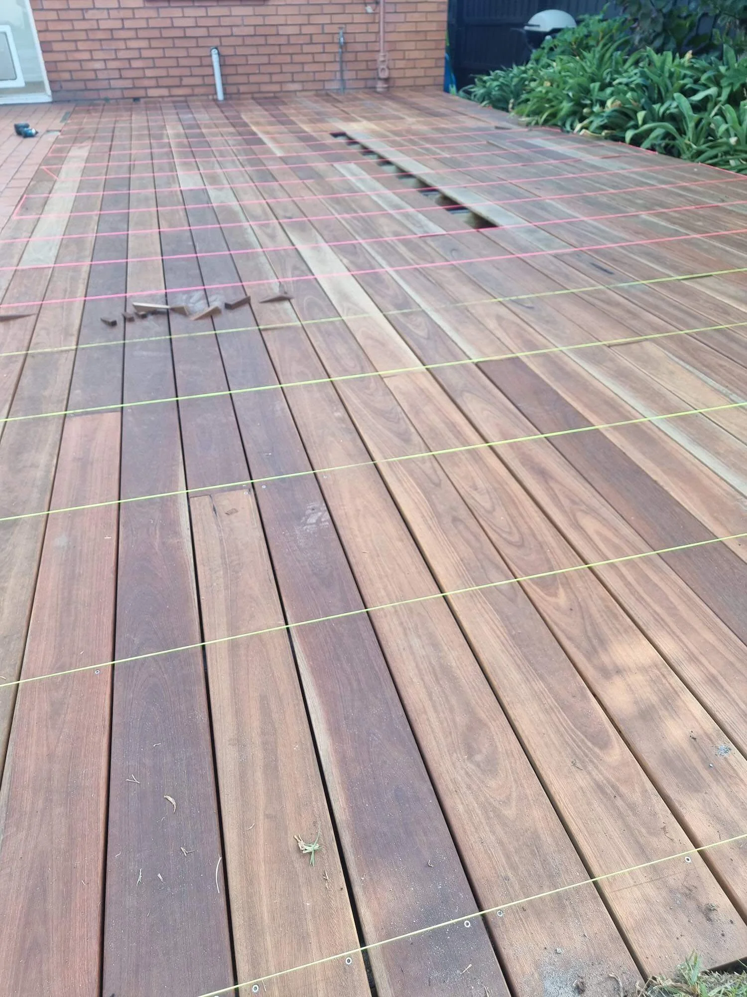 Wooden deck construction with string lines for alignment