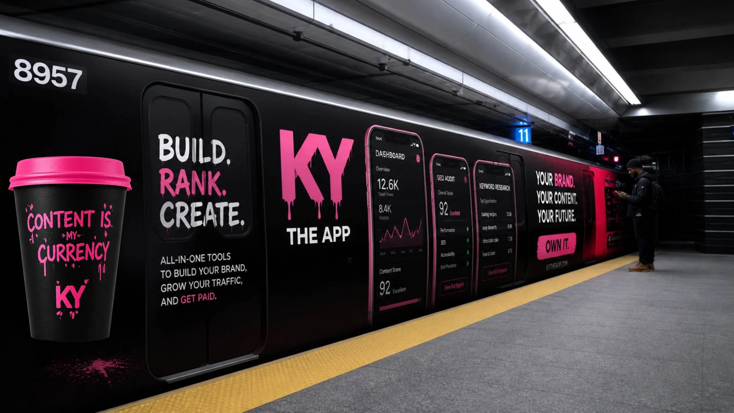 A black subway train wrapped in a bold hot pink KY The App advertisement showing a “Content Is My Currency” cup, “Build. Rank. Create.” text, mobile dashboard mockups, and the message “Your Brand. Your Content. Your Future. Own It.