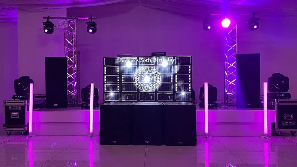ProWall LED Wall with DJ booth with purple lighting, speakers, and a digital display for a birthday party.