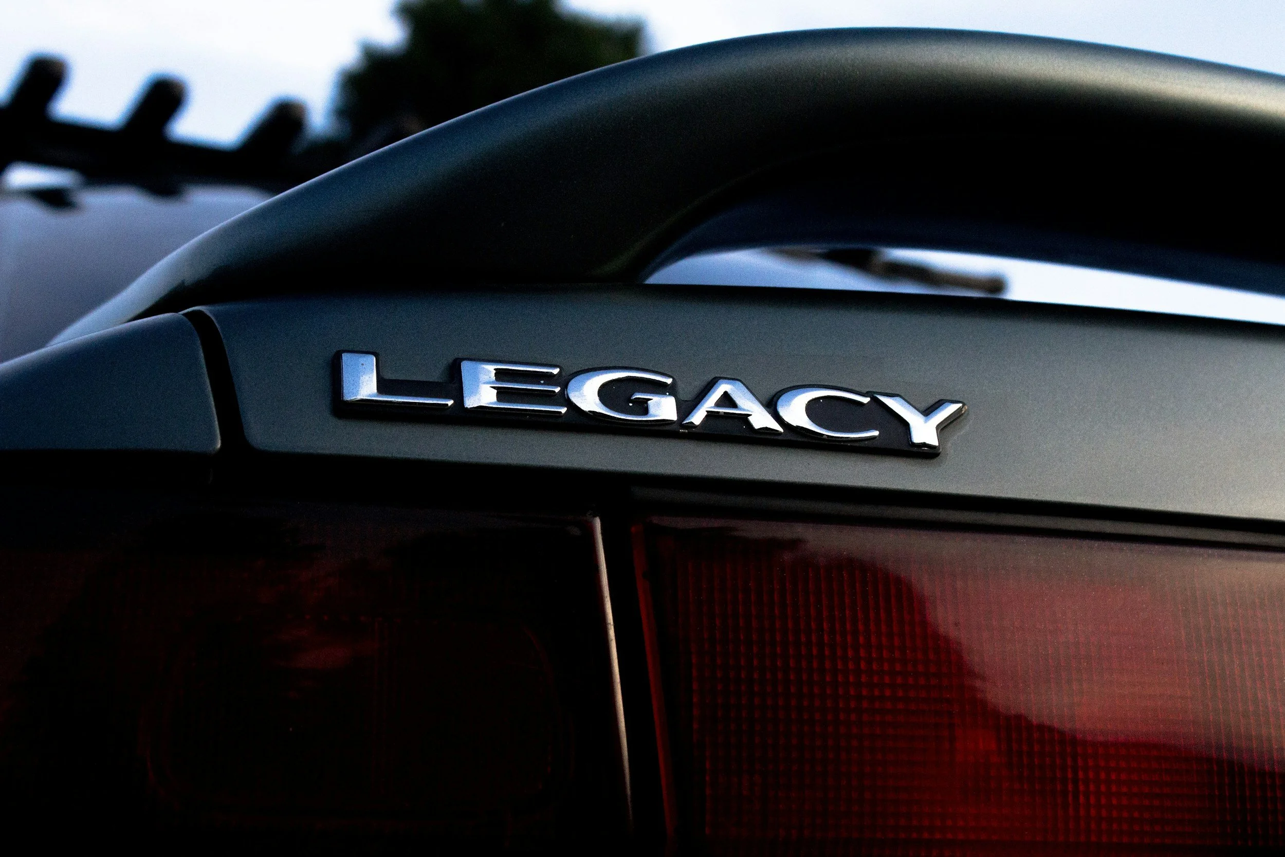 The word LEGACY on the rear of an automobile