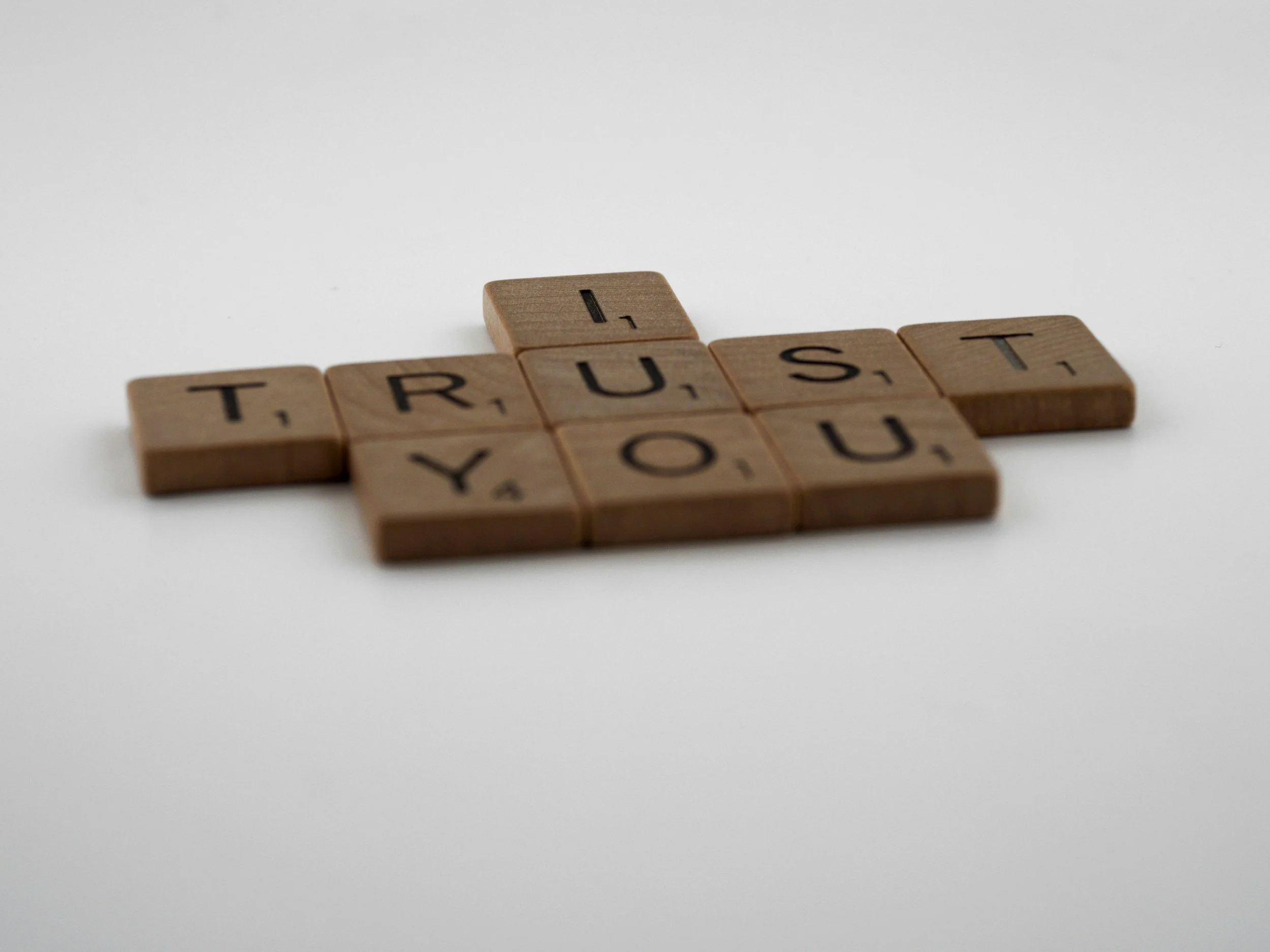 Scrabble letters spelling 'I Trust You'