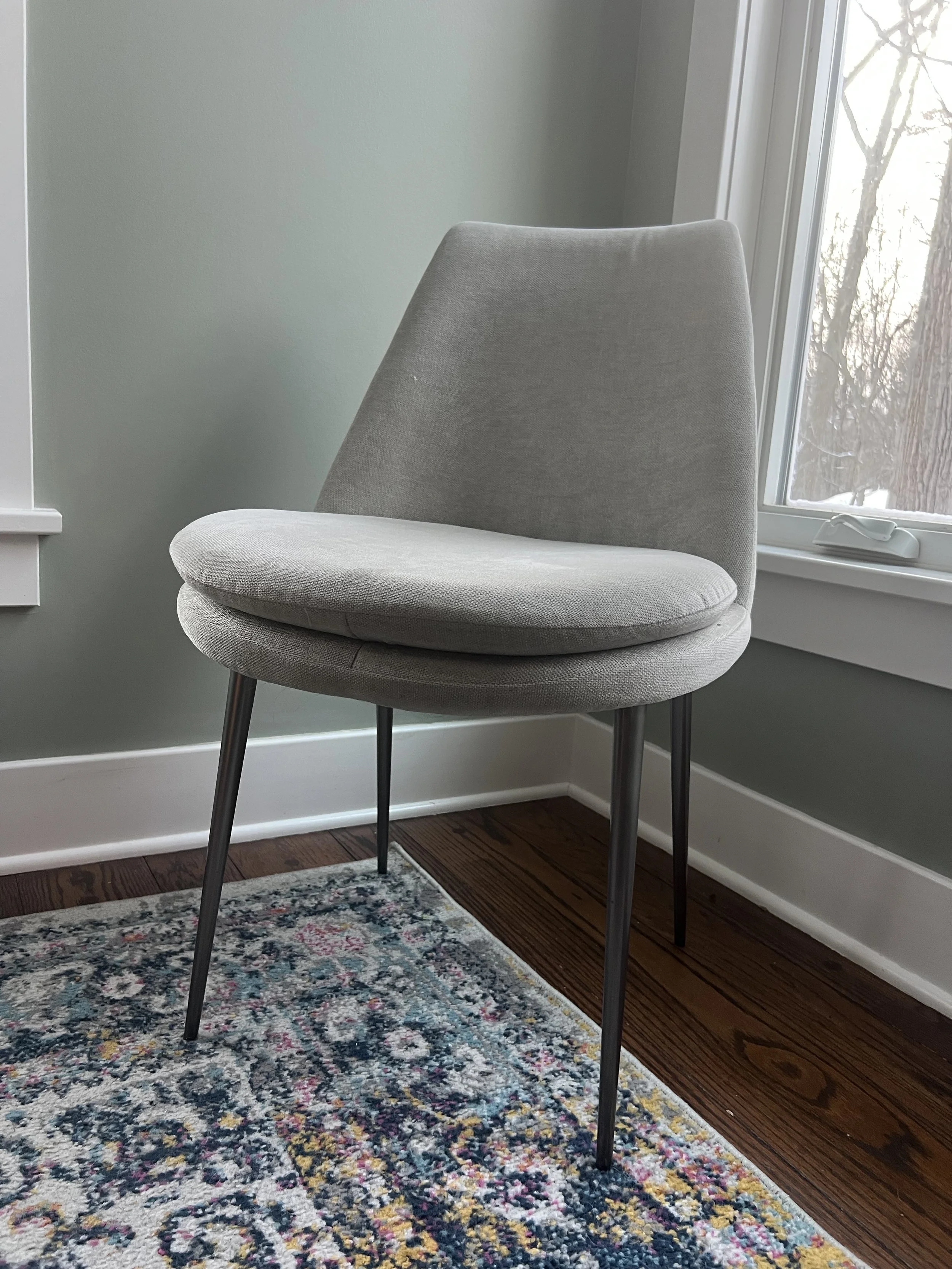 Empty fabric dining room chair in a corner