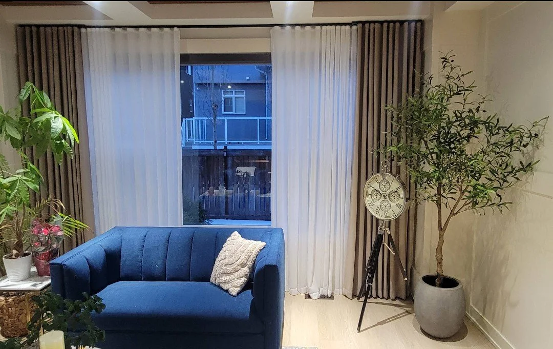 It shows the after of the installation of the custom made curtains by Aby Unik Group in Calgary, the color of the curtians are white and sand,