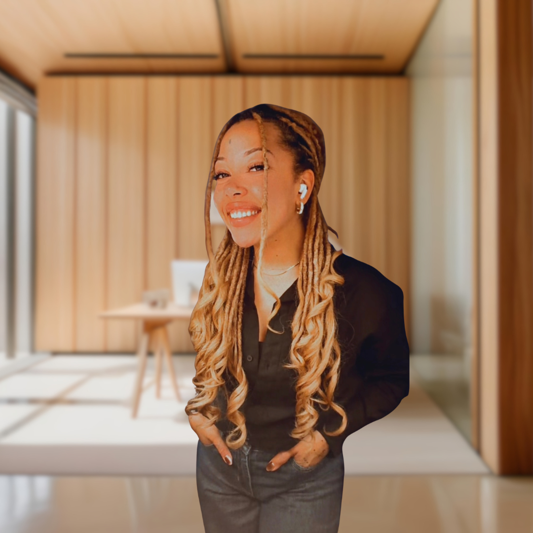 A woman with long blonde braids smiling in a modern, wood-paneled room.