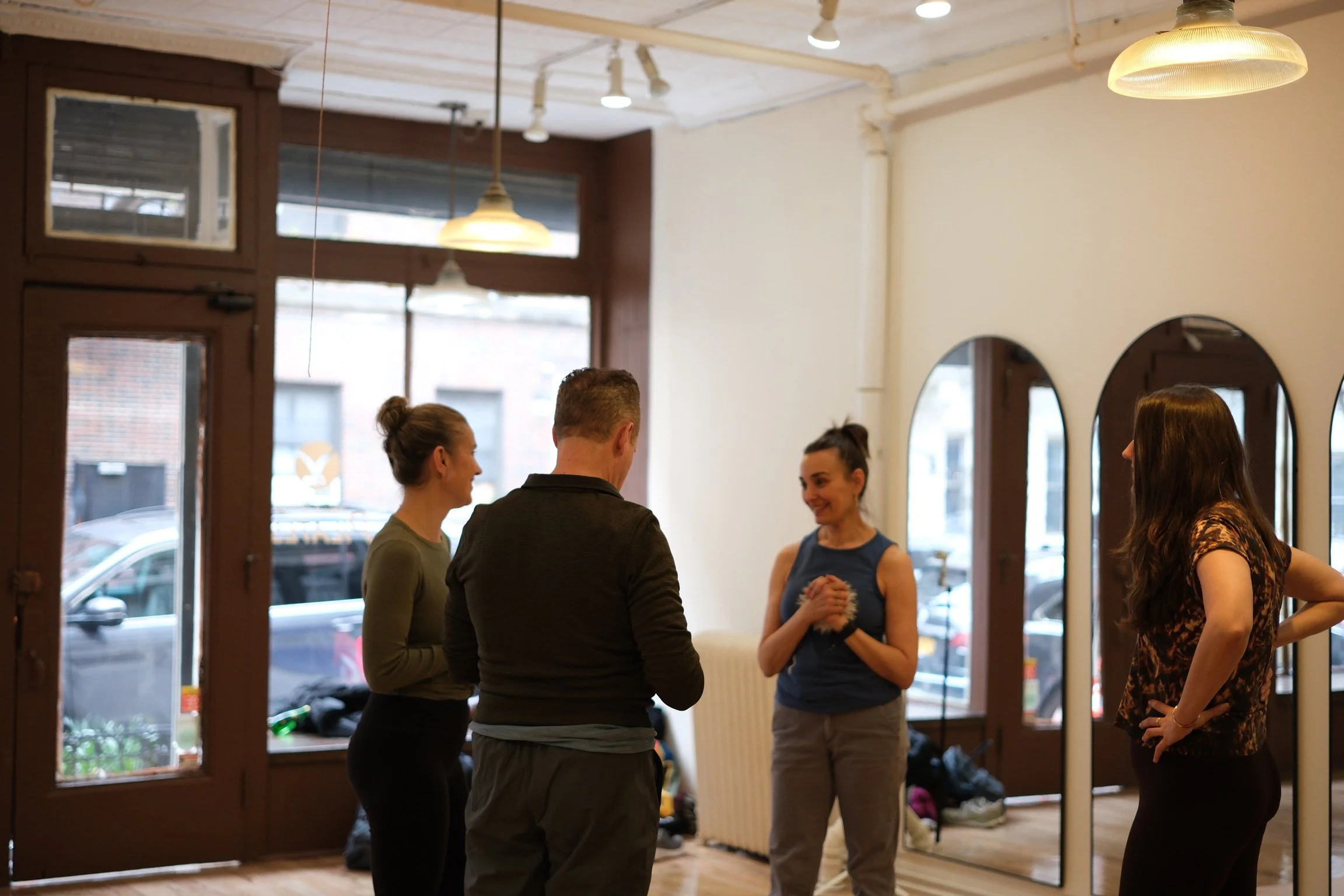 Pilates instructor leading a professional development workshop for teachers in Hell's Kitchen
