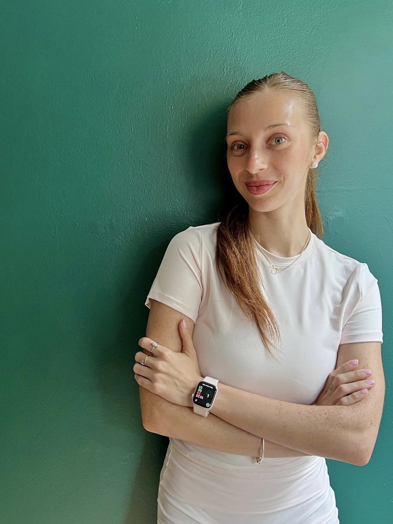 Sofía Ameglio, Pilates instructor at Hell's Kitchen Pilates, wearing a white t-shirt with arms crossed