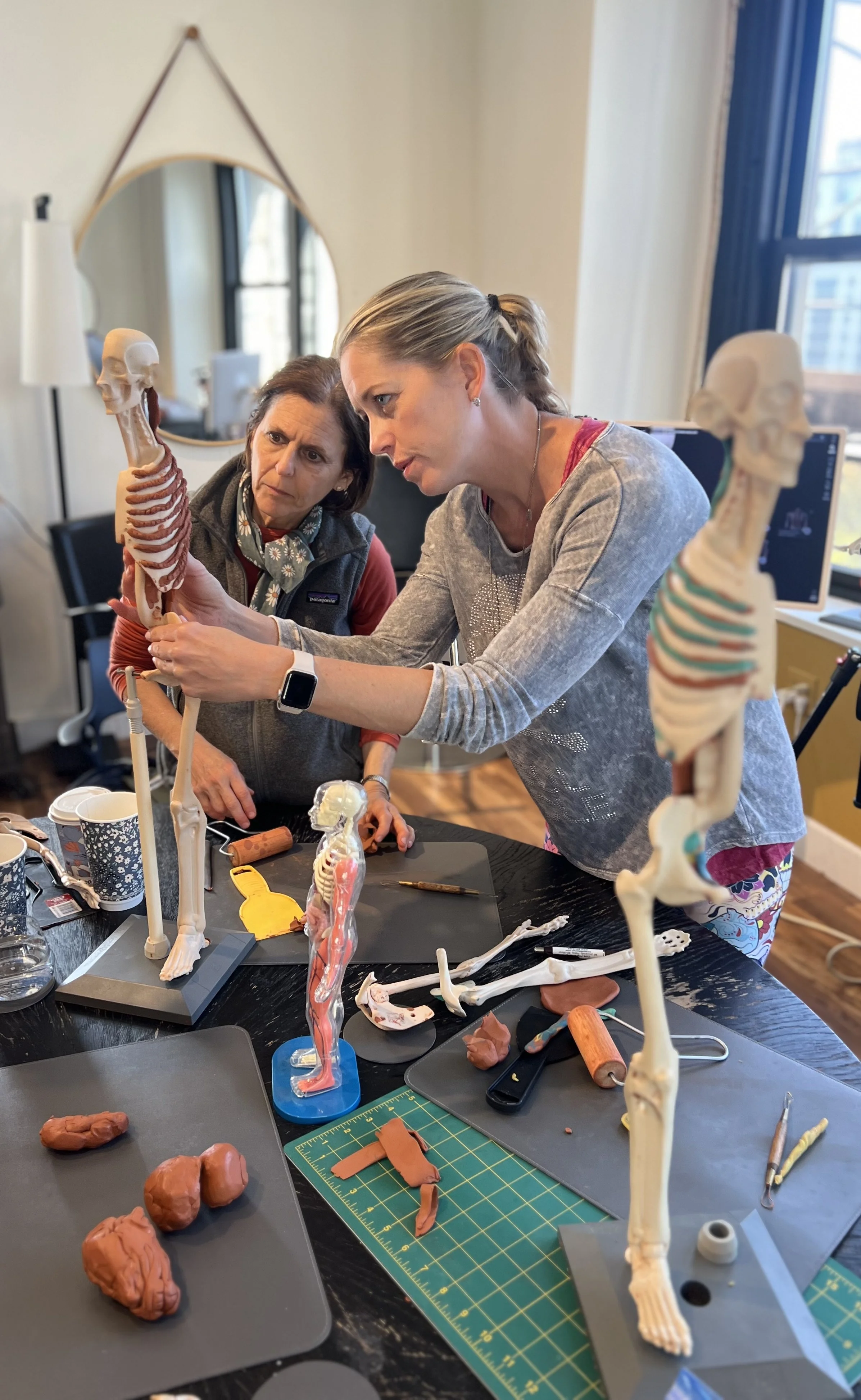 Collage of scenes from Pilates anatomy workshops at Hell's Kitchen Pilates, featuring students learning with skeleton models and group instruction