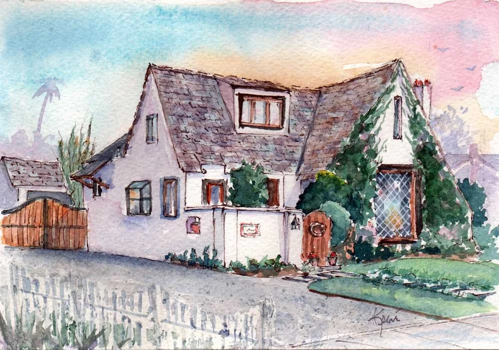 Watercolor painting of a cozy house with a steep roof, a large window on the right, and a small window on the upper level. The house is surrounded by greenery and a white picket fence in the foreground. A gate and pathway lead to the front door, with