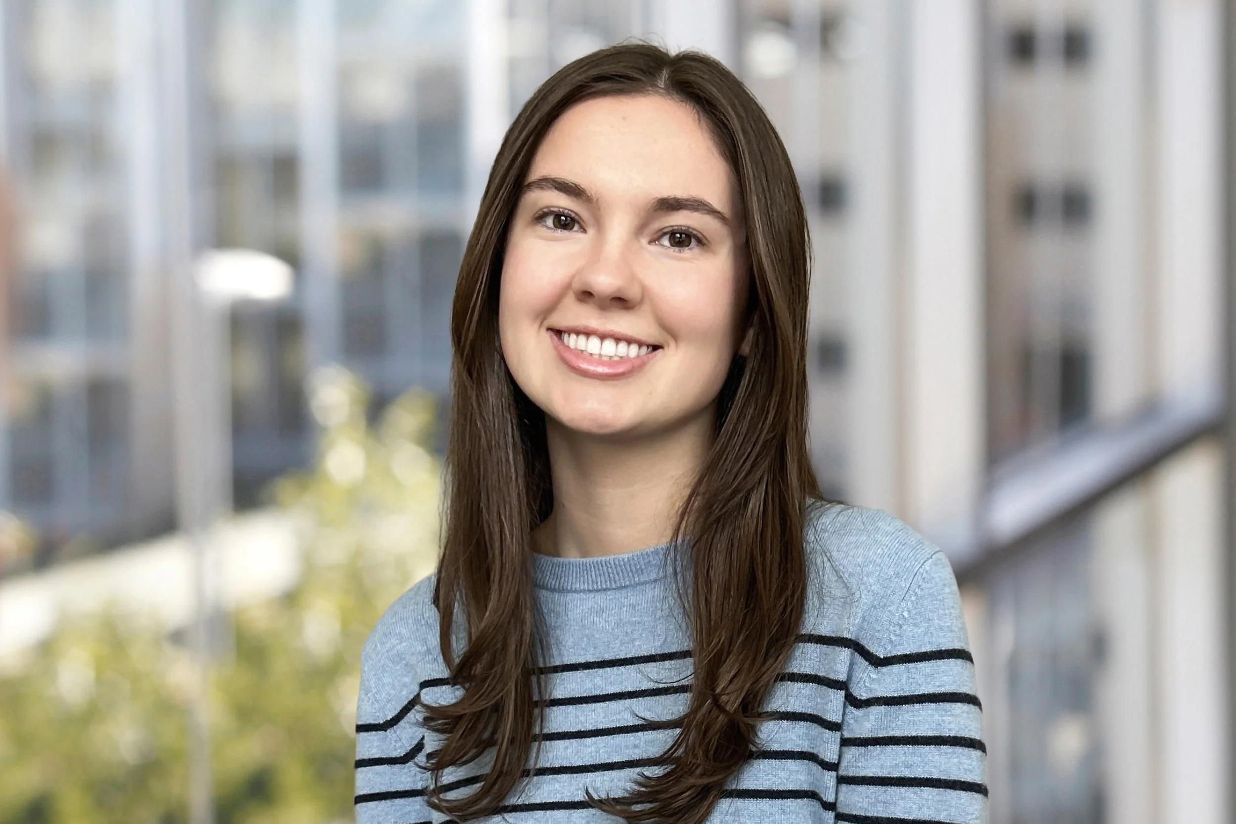 A young woman with long hair smiling.
