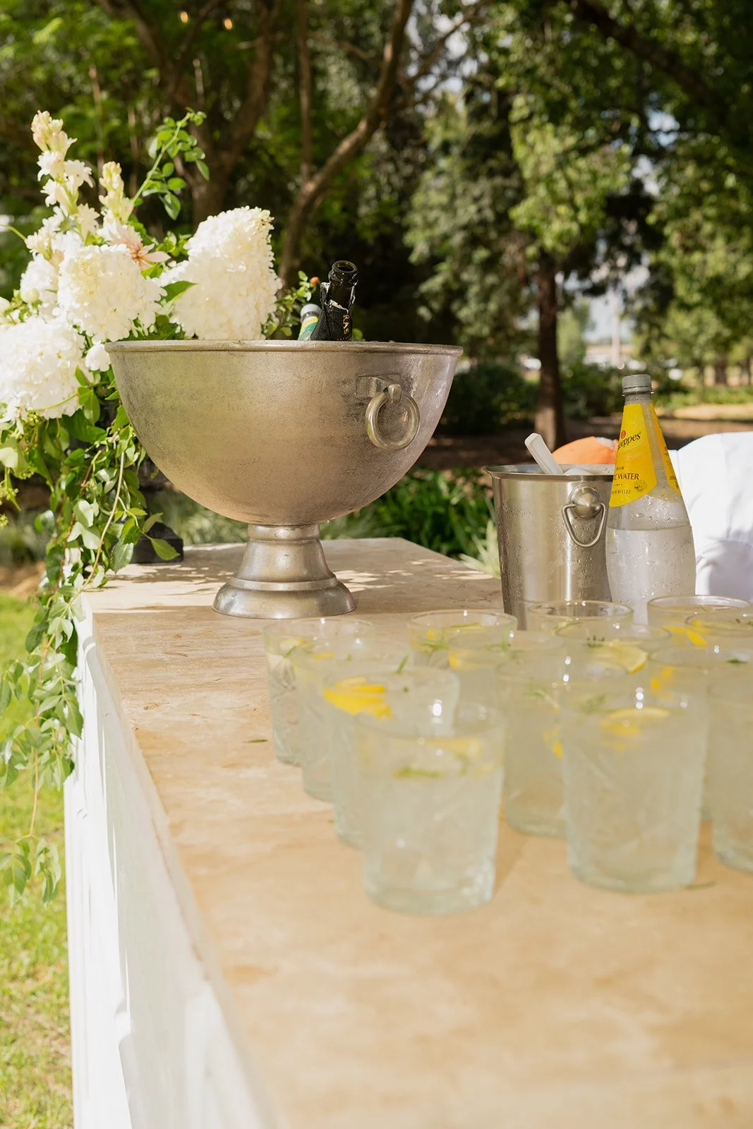 Beautifully styled wedding lounge area at Rawson Park Homestead near Wagga Wagga, NSW, featuring a sofa, floral arrangements and elegant glassware.