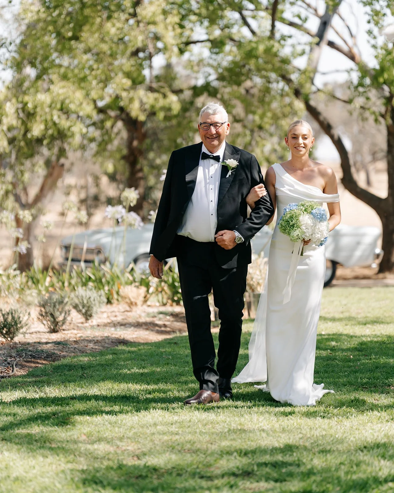 ALT text – Garden Wedding Ceremony
Bride walking down the aisle with her father in the beautiful garden ceremony area at Rawson Park Homestead near Wagga Wagga, NSW.