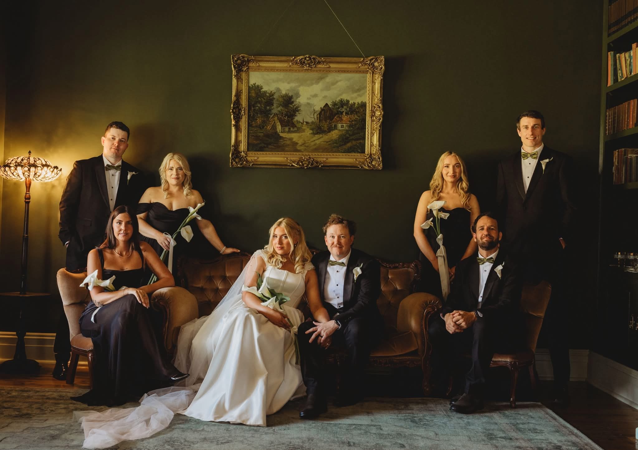 Wedding party posing in the elegant formal lounge of Rawson Park Homestead near Wagga Wagga, NSW, capturing the timeless charm of a bygone era.