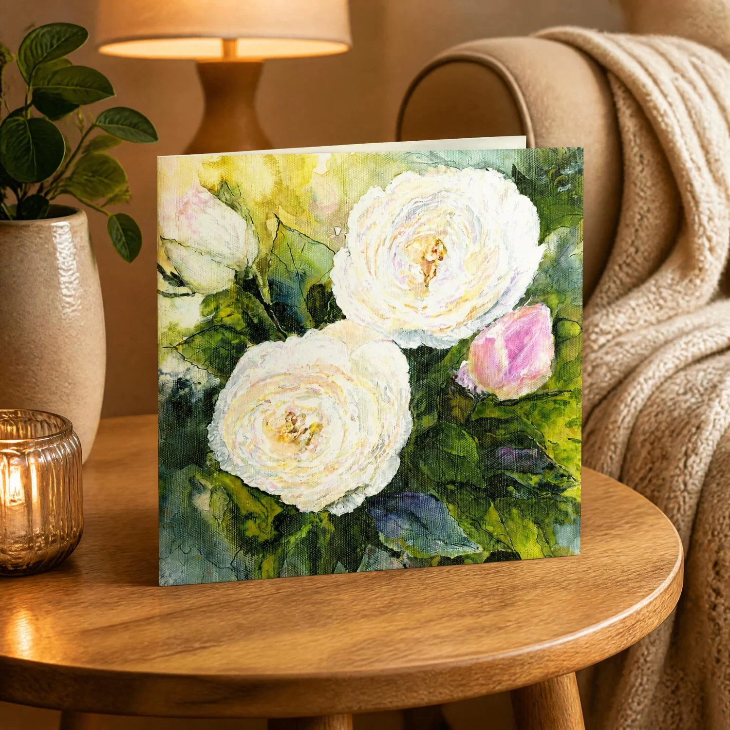 cosy room with a David Austin Desdemona rose greeting card by Sarah Elliott with white and blush roses and green leaves.