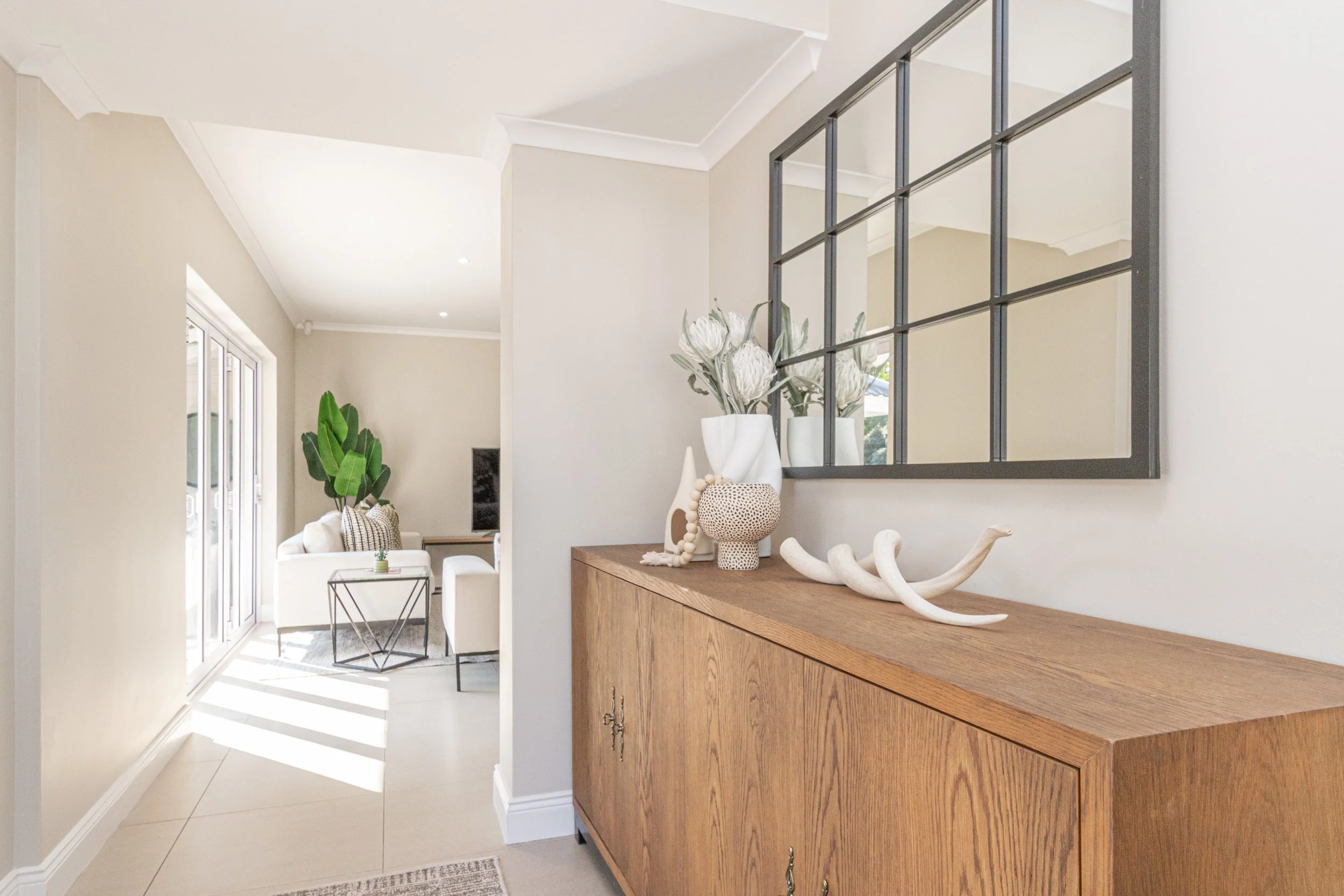 light-filled entrance with timber mirror styling at willow house