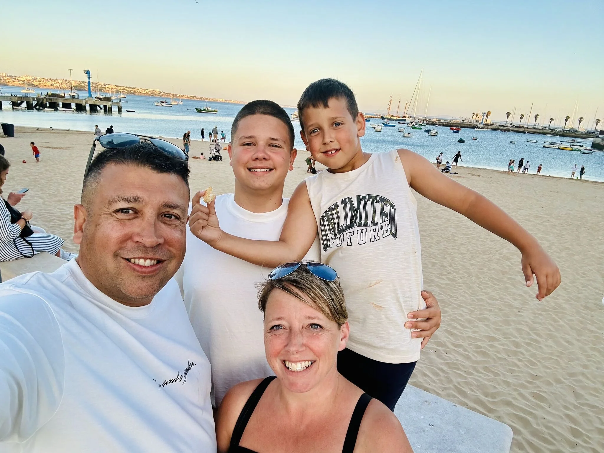 Image of Nigel, Founder of Adult Proof, smiling to the camera whilst on the beach with his family