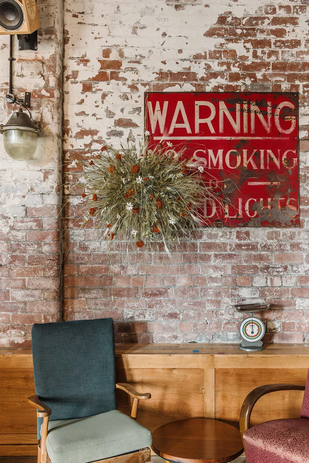 Mid-century modern inspired bar decor with dried flower wall hanging
