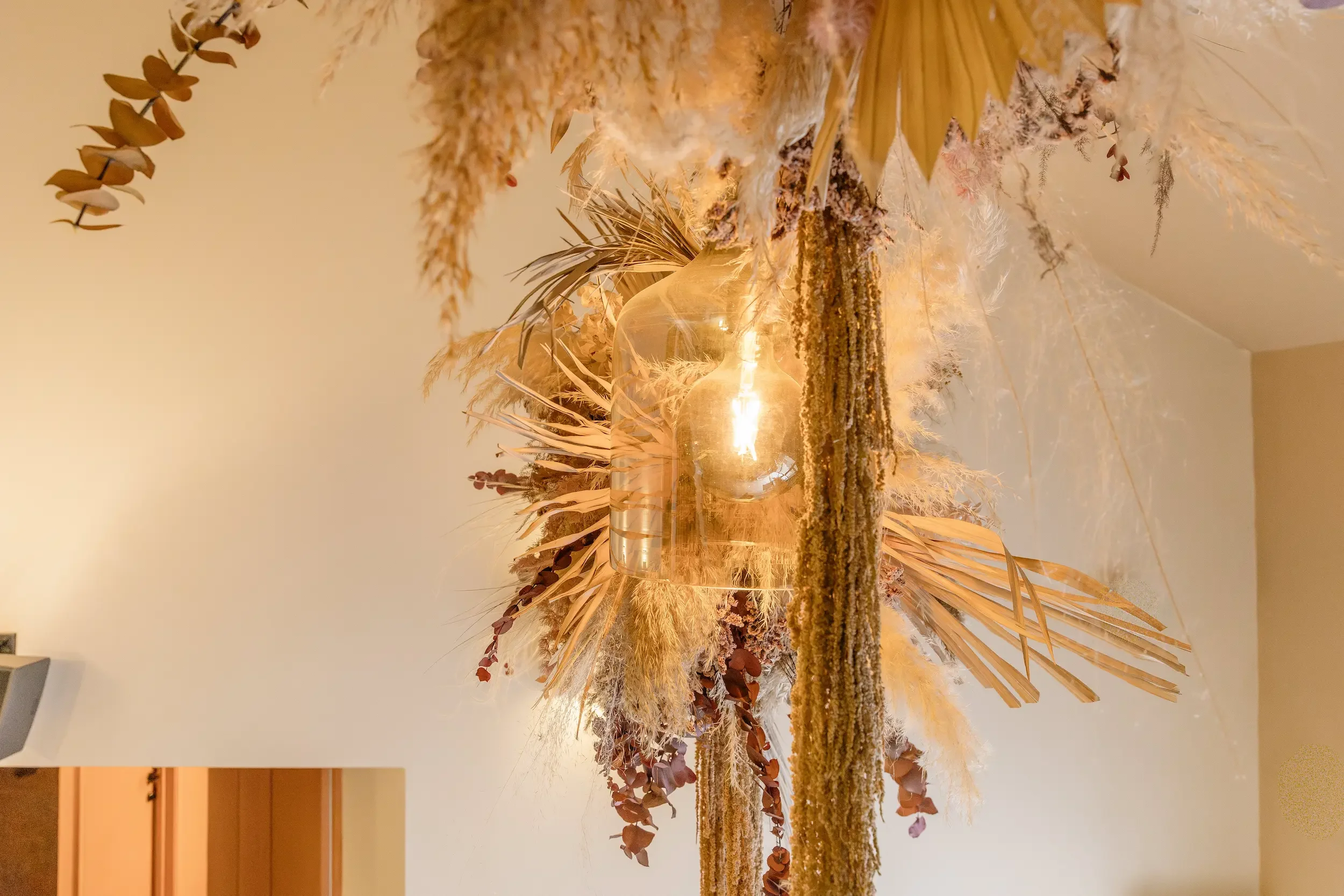 Close-up detail of suspended dried flower installation with pampas, palm and preserved eucalyptus at Life and Lemons Clinic, Sheffield