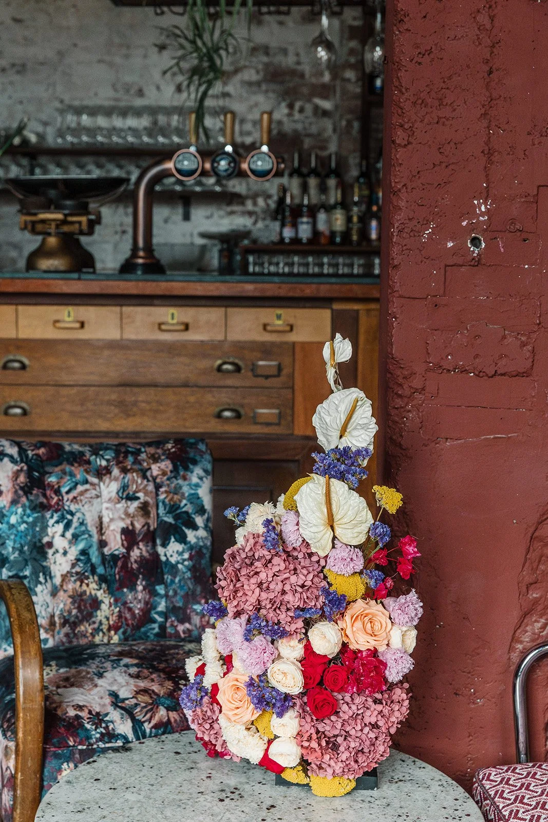 Colourful floral centrepiece on a table in a bar setting