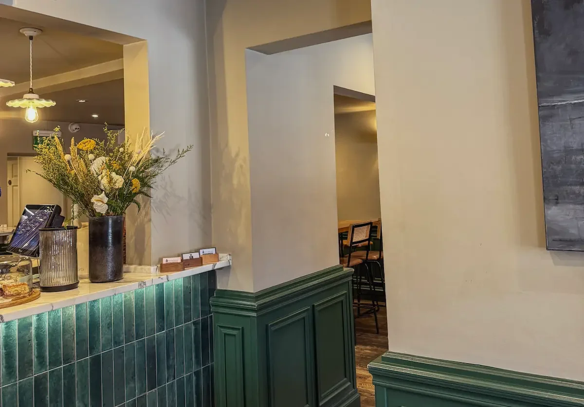 Landscape view of back room entrance and bar floral display at Kilo Wine Bar