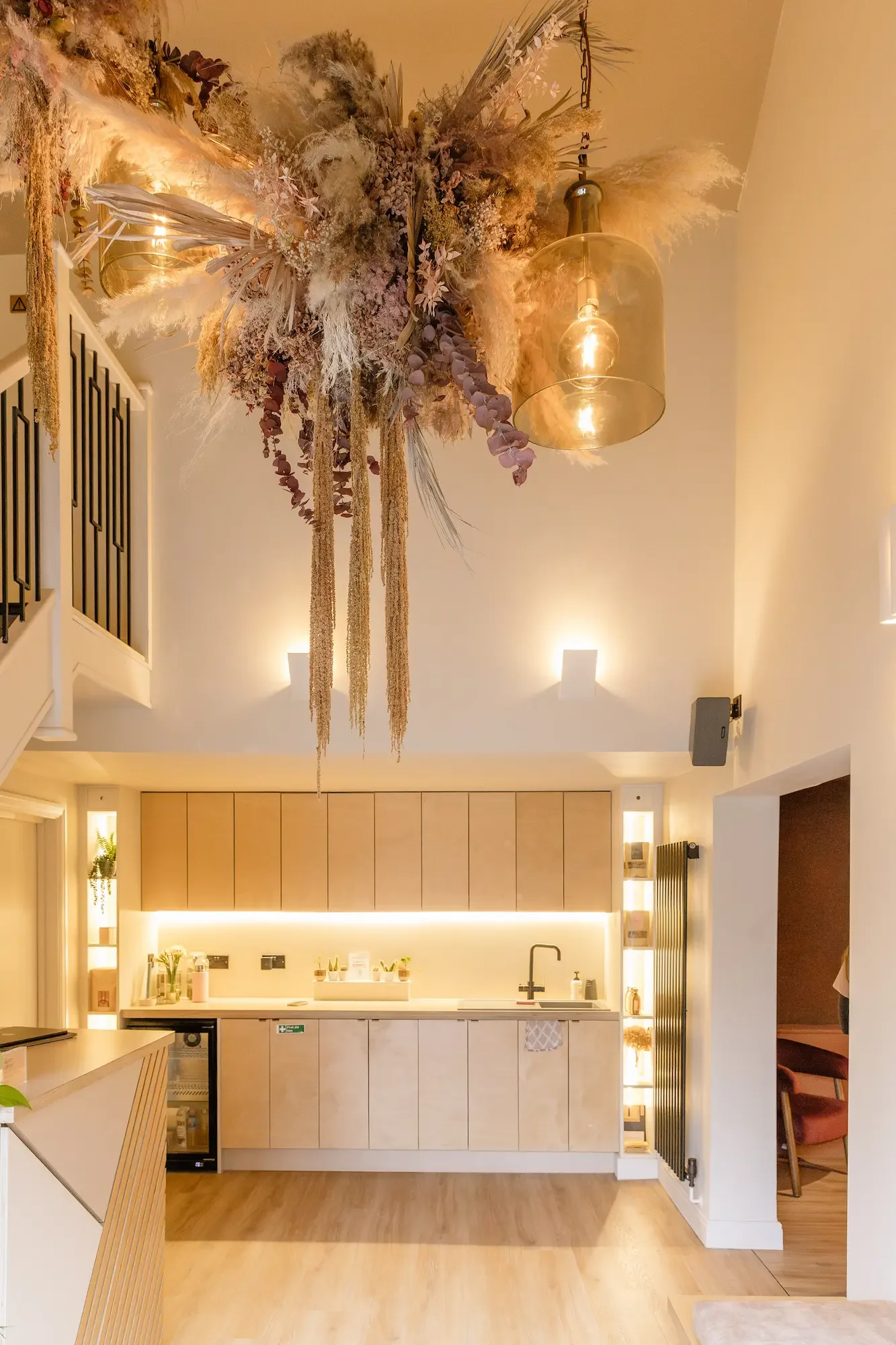 Dried flower ceiling installation above the reception counter at Life and Lemons women's wellness clinic, Sheffield, by Anther Studio