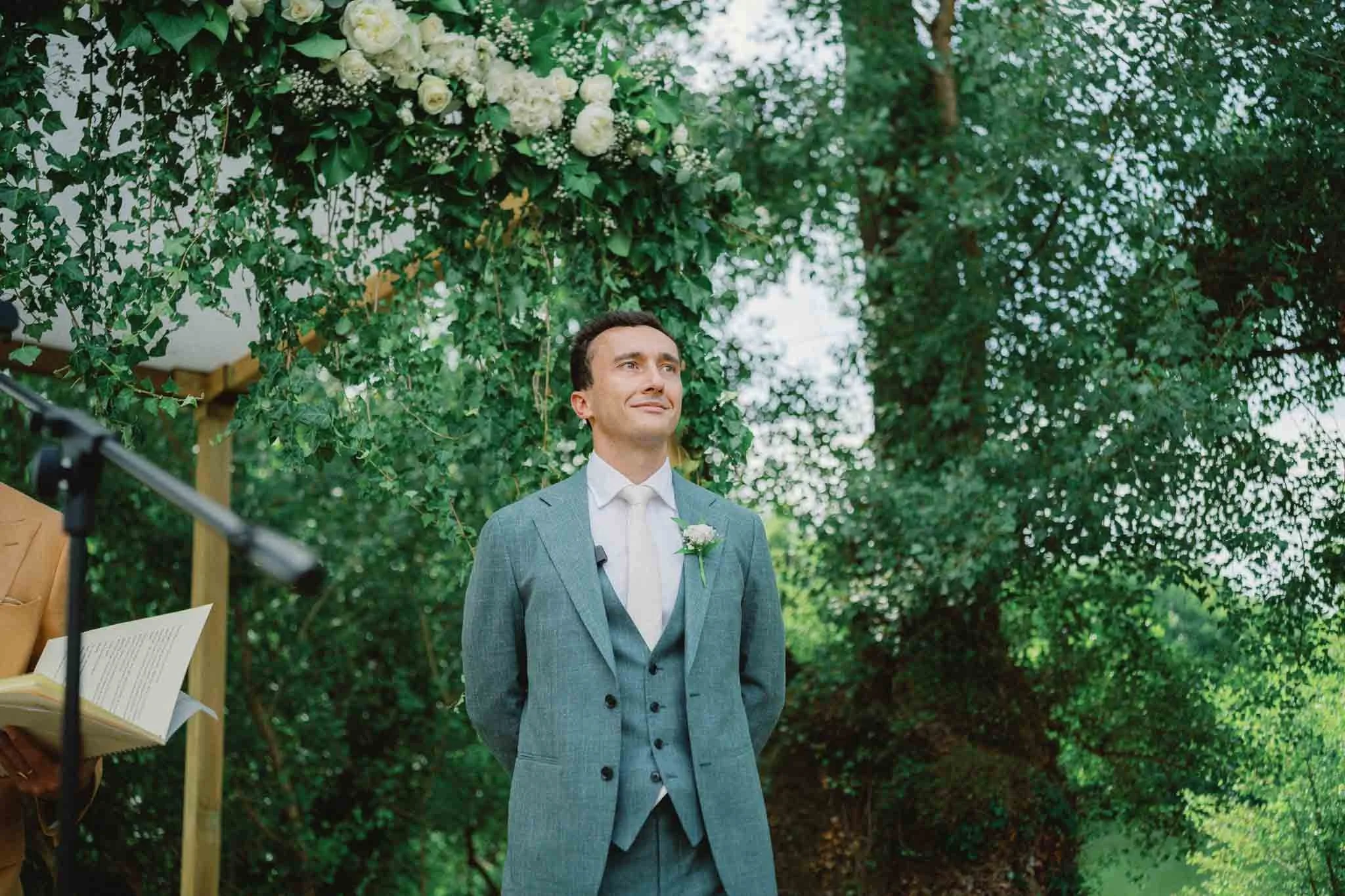 Groom looking up while waiting at the ceremony at Château Lagorce, Bordeaux