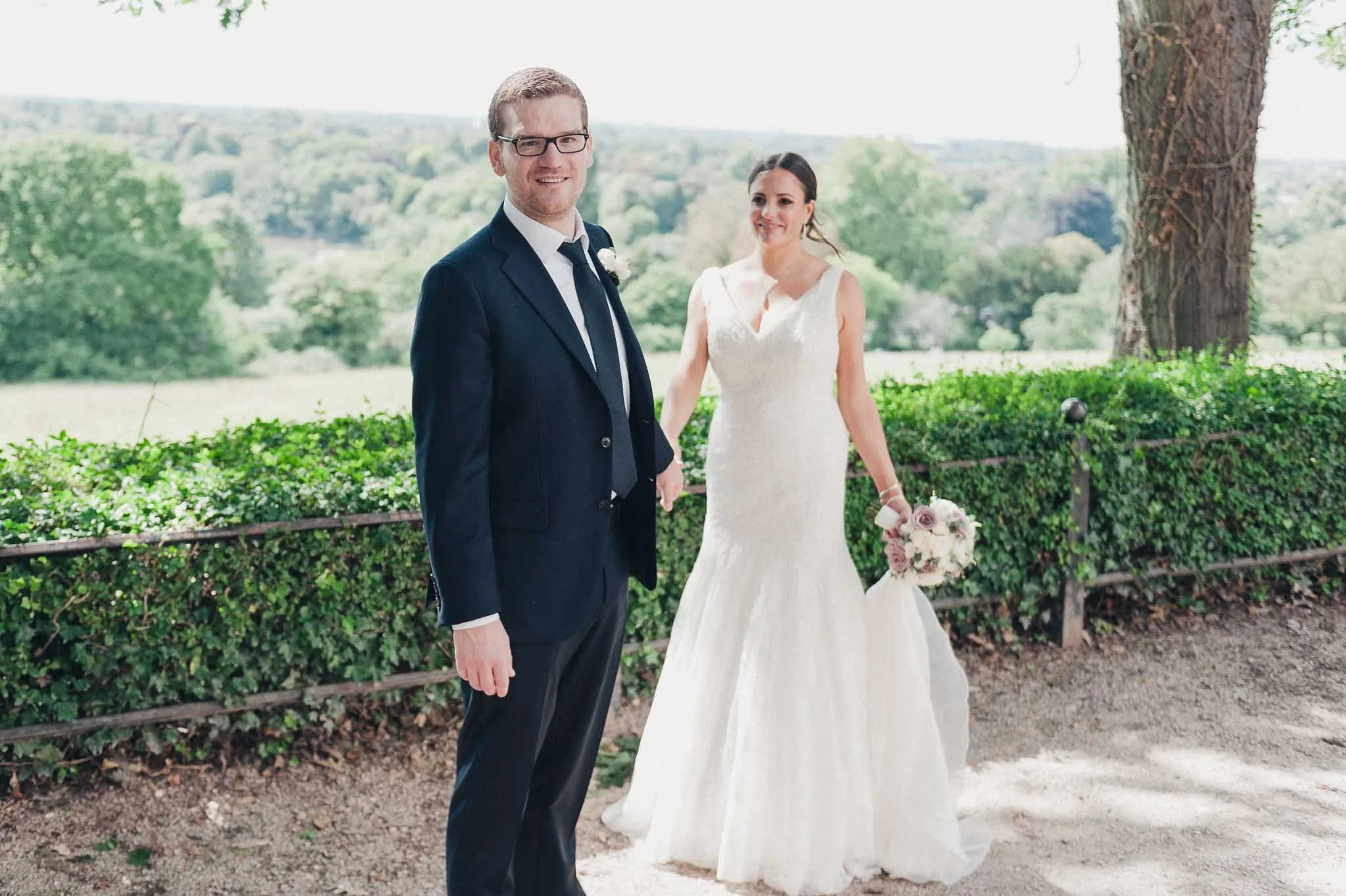 Bride and groom holding hands outdoors after the ceremony at Richmond Hill Hotel.