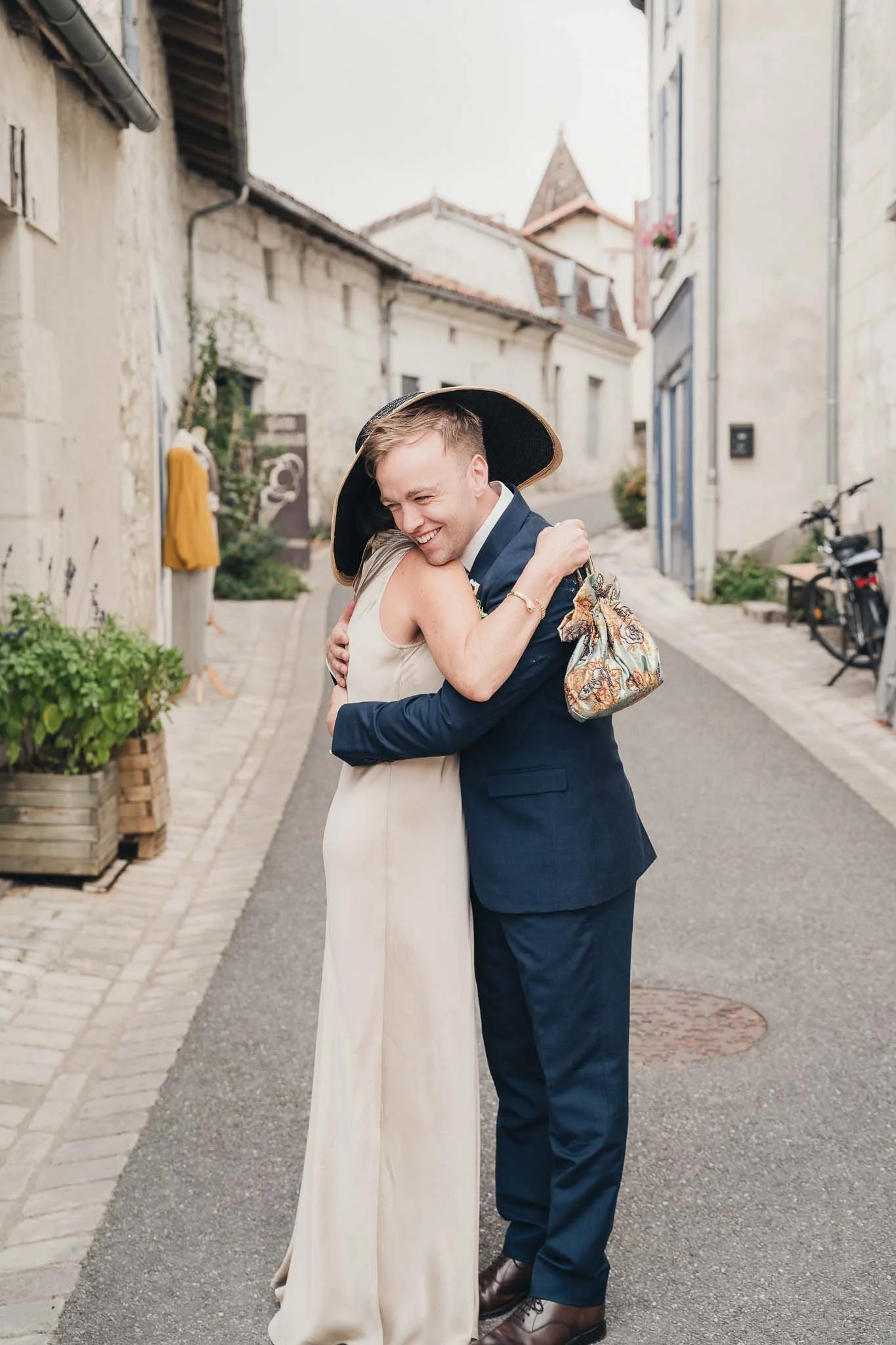 Groom hugging Mum in the streets of Aubeterre-sur-Dronne.
