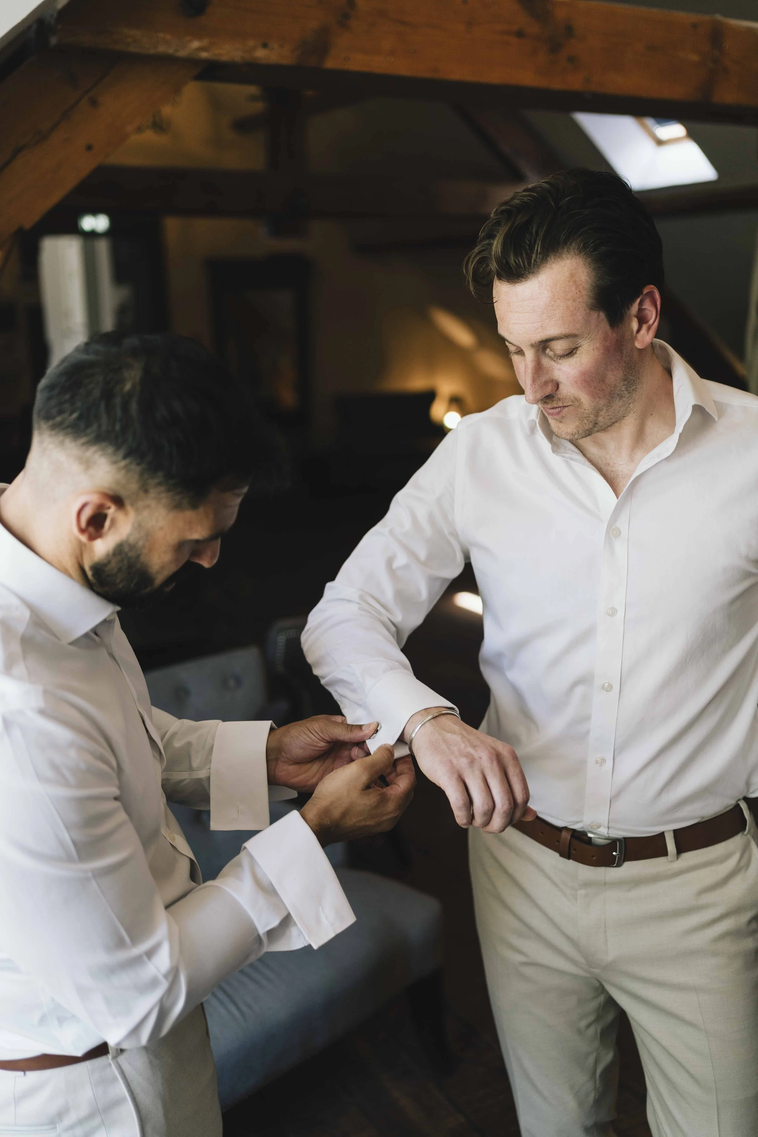 Groom and best man preparing on the morning of a wedding in the Dordogne, France