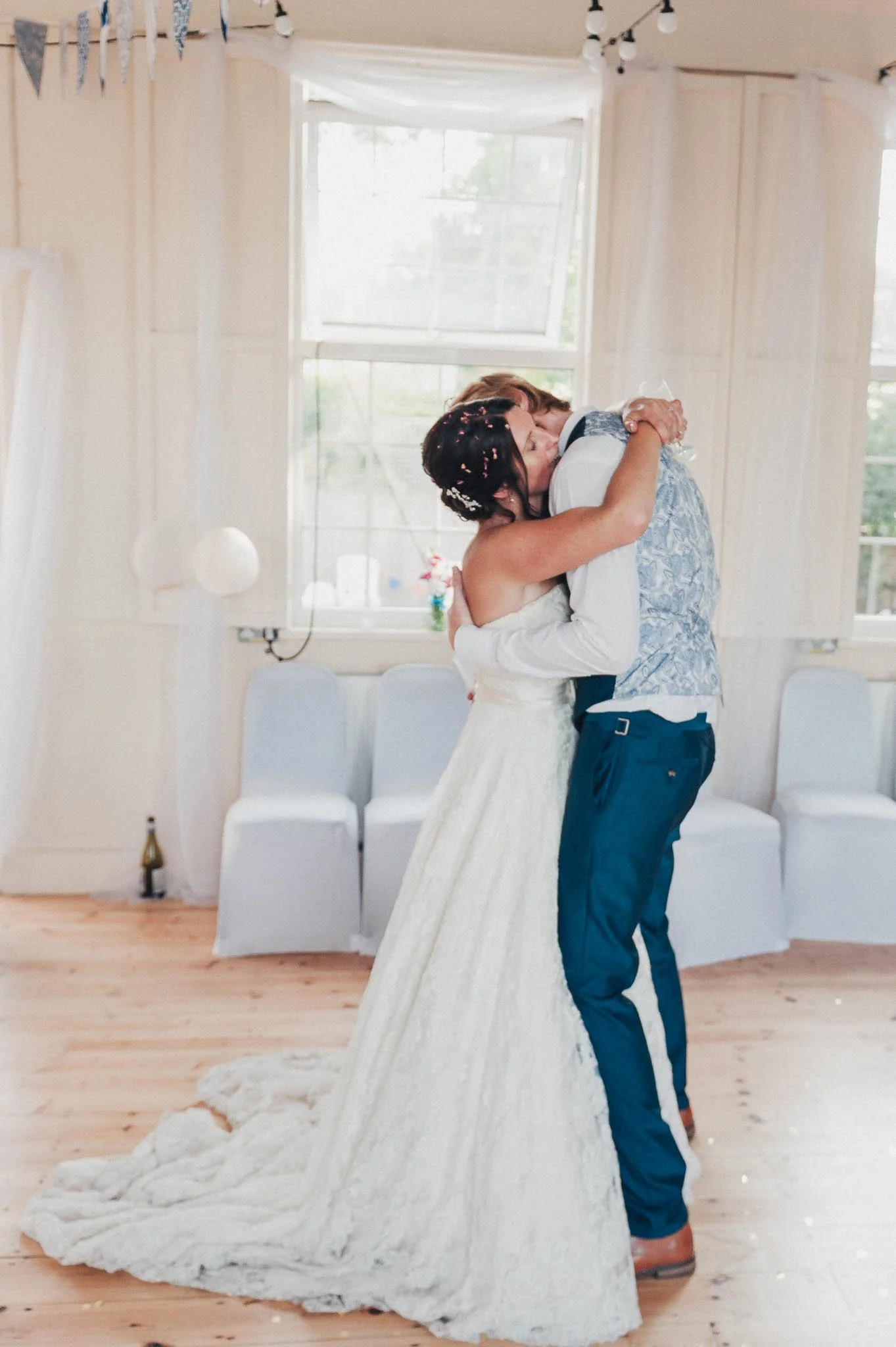The bride and groom sharing a slow dance and holding each other closely.