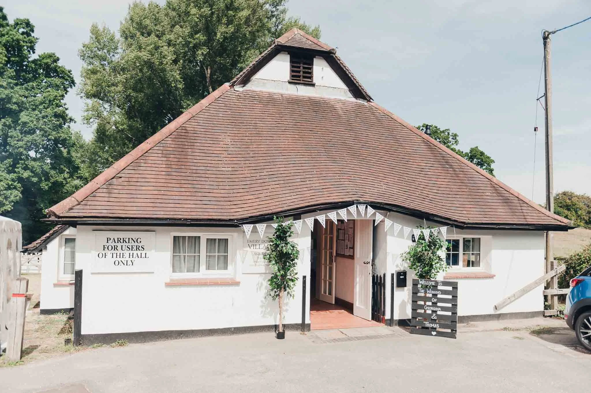 Small village hall decorated with bunting on the wedding morning.