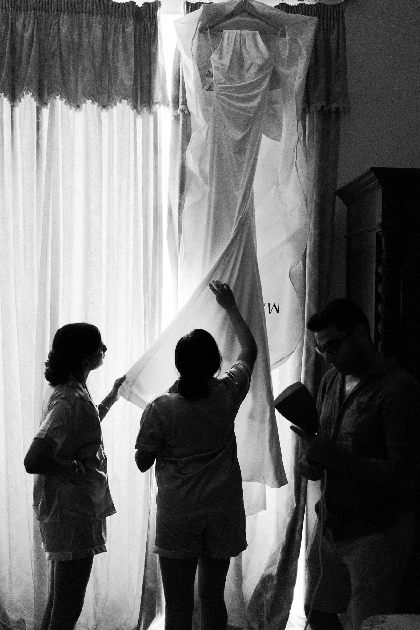 Wedding party steaming and preparing the dress during getting ready at a Southwest France wedding