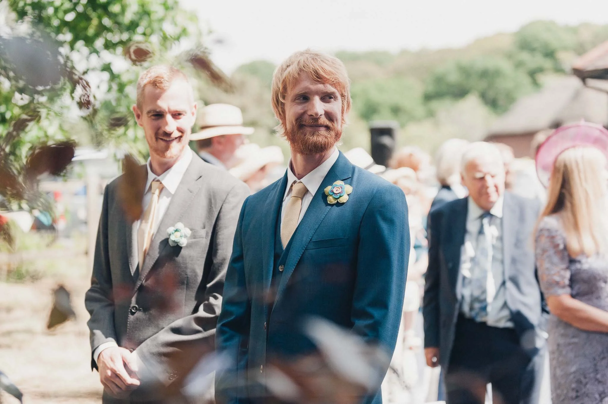 The groom and best man waiting at the front of the outdoor ceremony area.