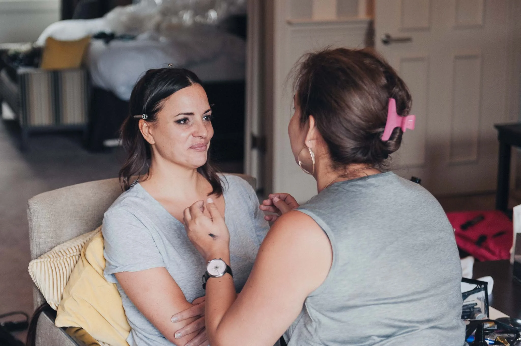 The bride having her makeup touched up during bridal preparations.